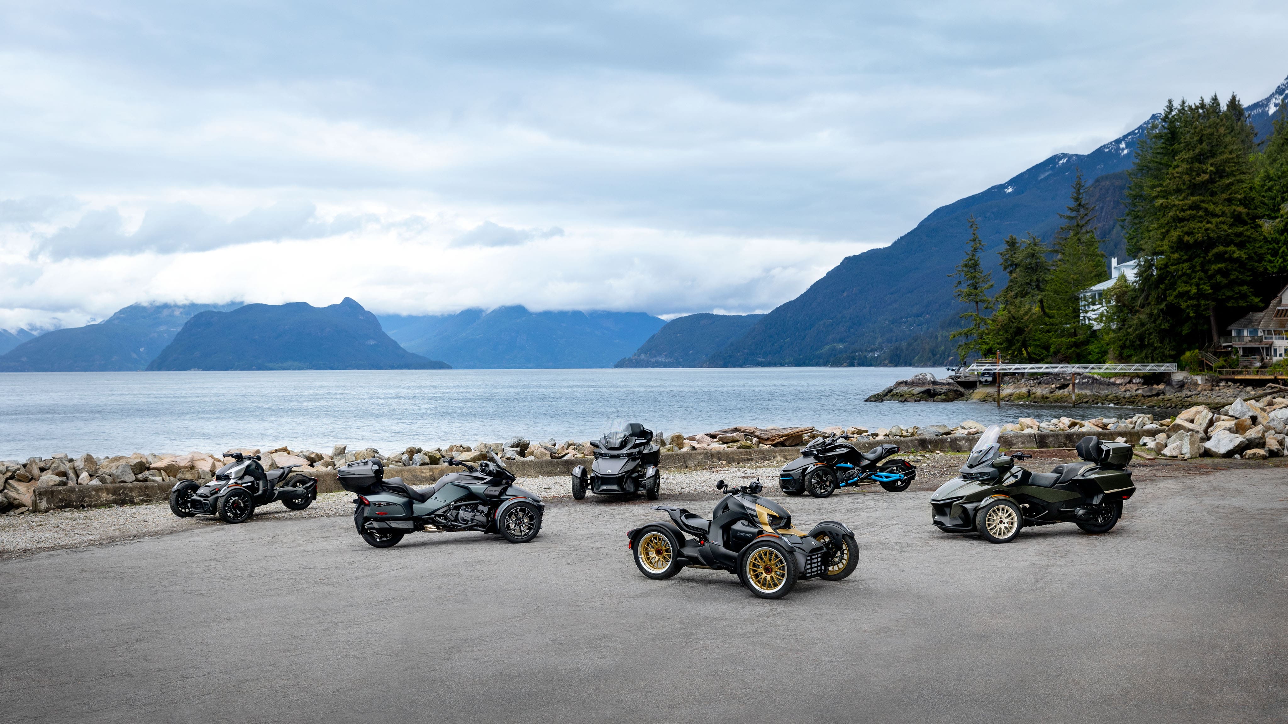 2023 Can-Am On-Road vehicle lineup posed on a scenic ocean overlook