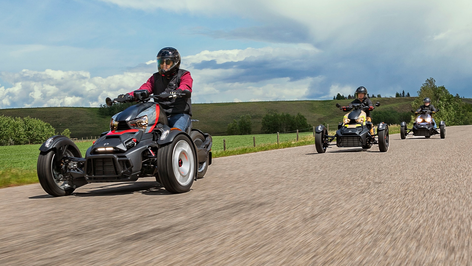 Three 3-wheel Can-Am On-Road vehicles driving on street