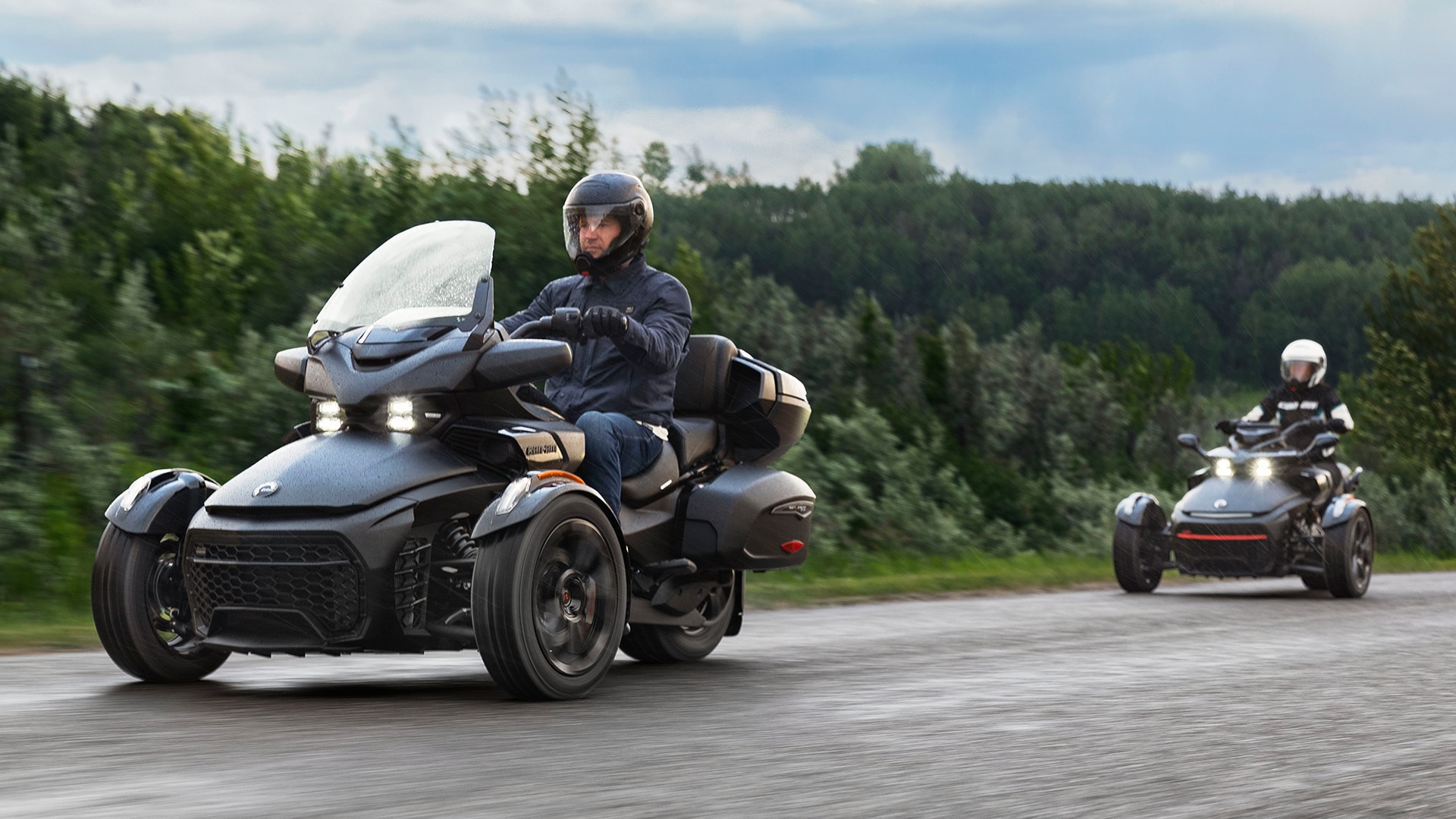 Two Can-Am riders riding with their 3-wheel motorcycle