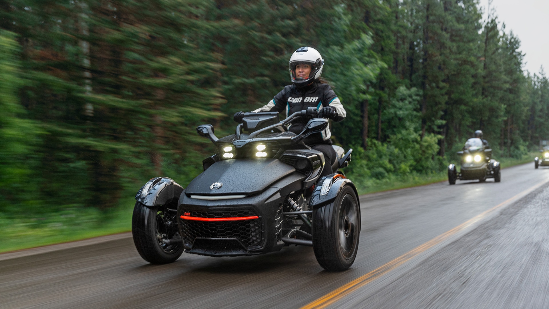 Woman riding a Can-Am Spyder F3 followed by two other riders