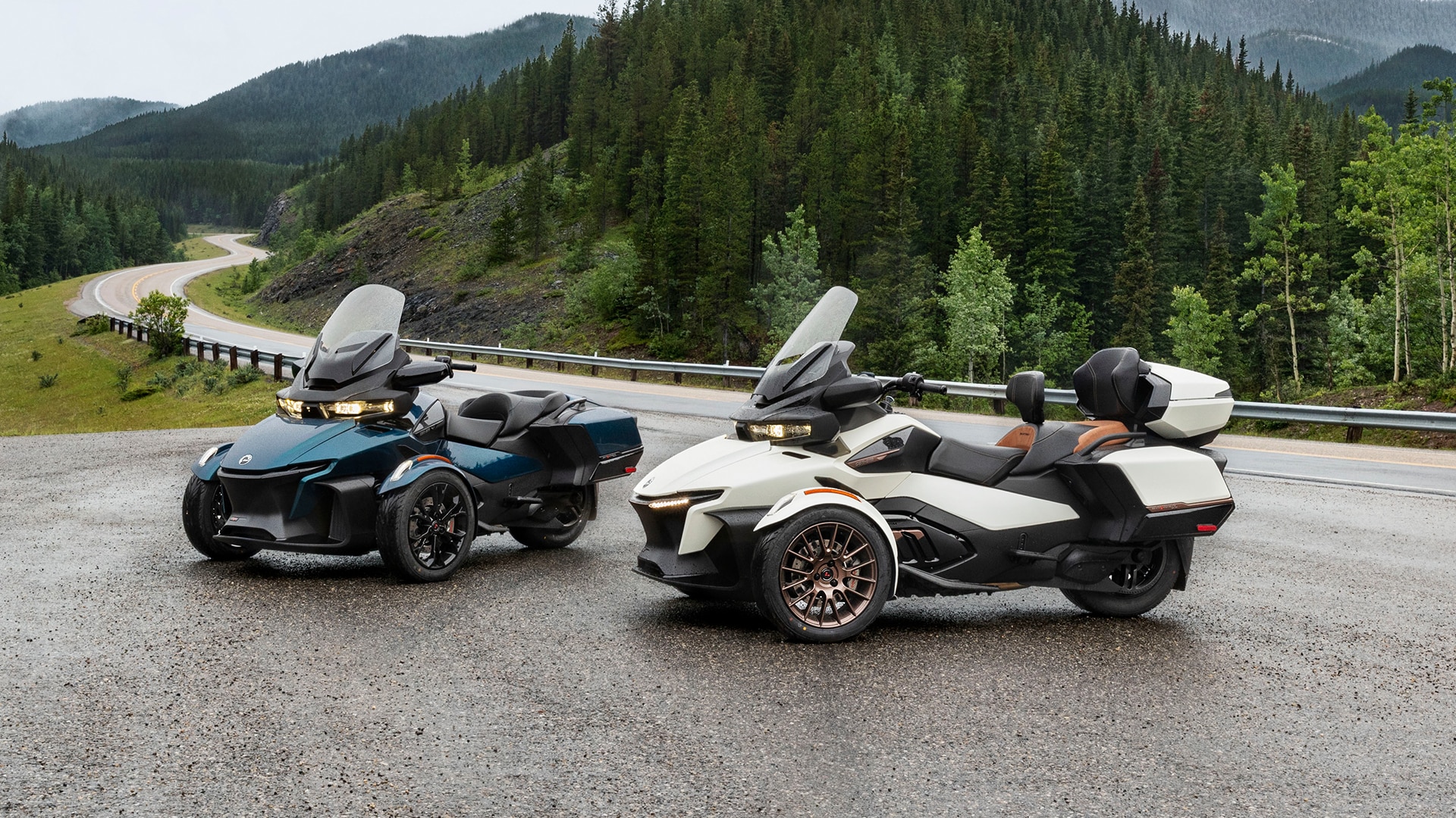 Two 2024 Can-Am Spyder RT next to a scenic road