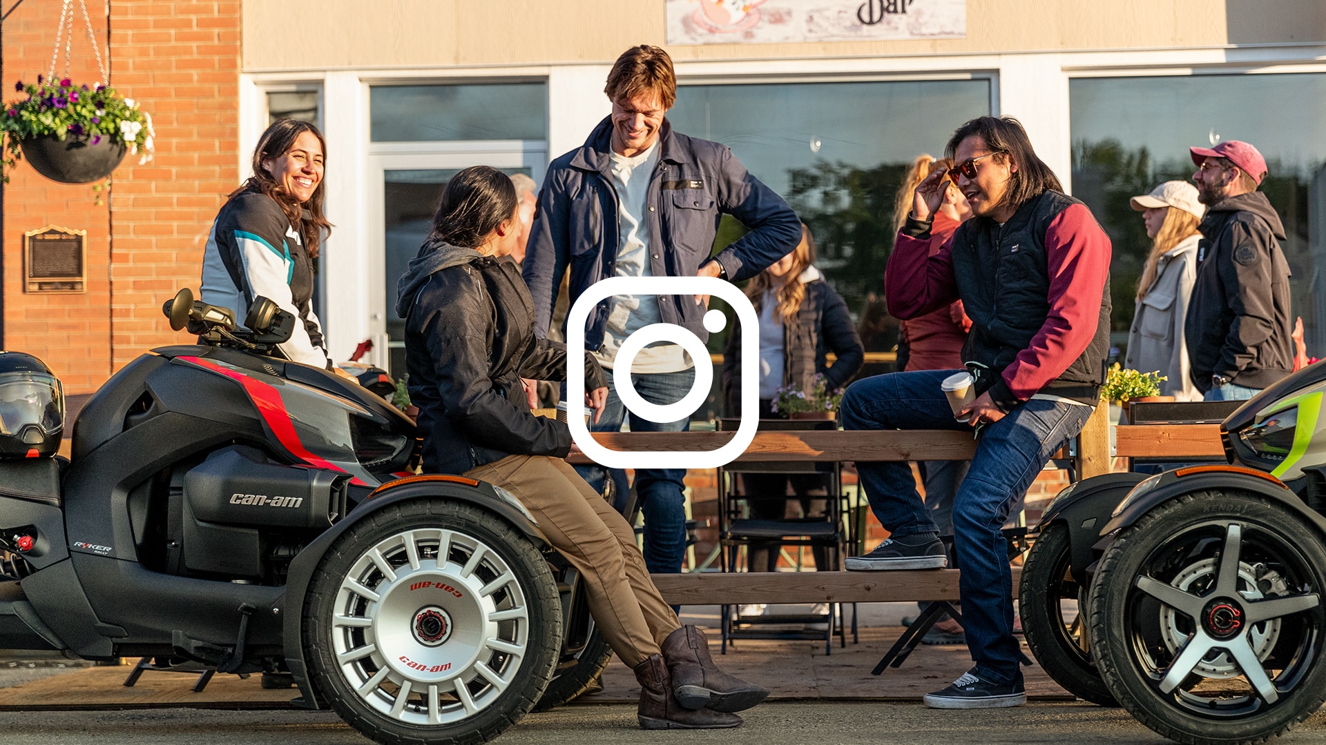 Three people laughing and talking on their Can-Am 3-Wheel vehicle with a Instagram logo over the image
