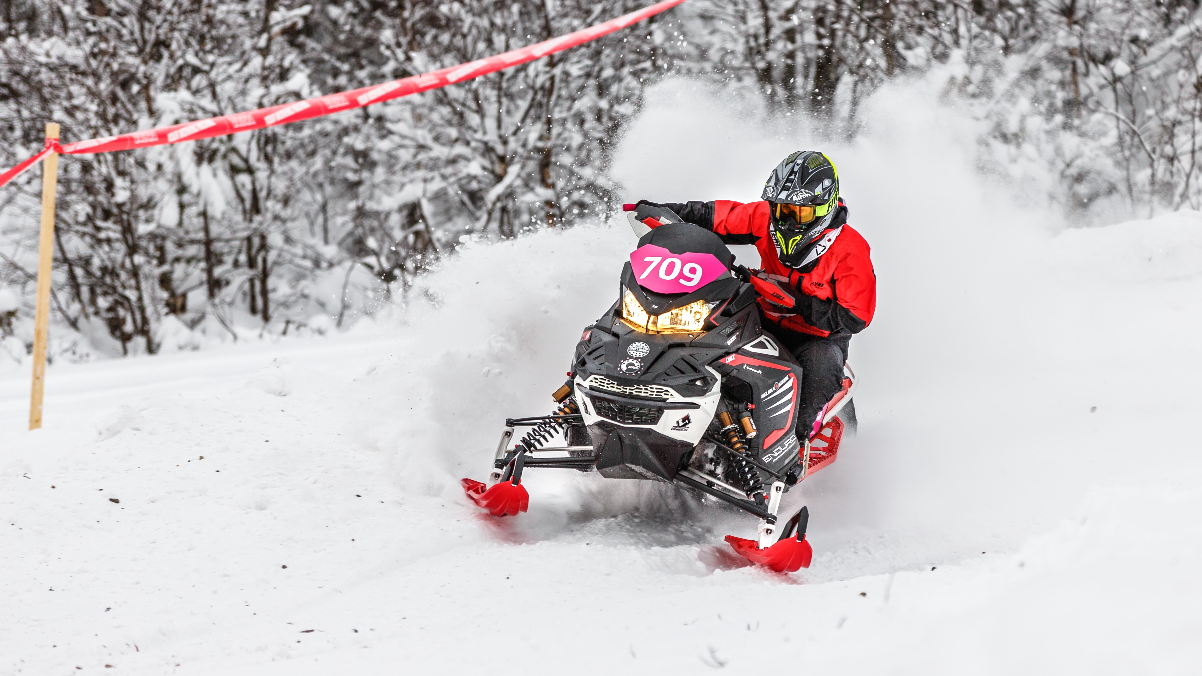 Lynx Rave Enduro snowmobile riding on race track