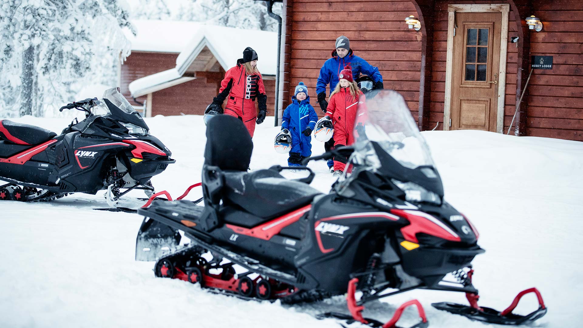 Family going riding with Lynx Adventure snowmobiles