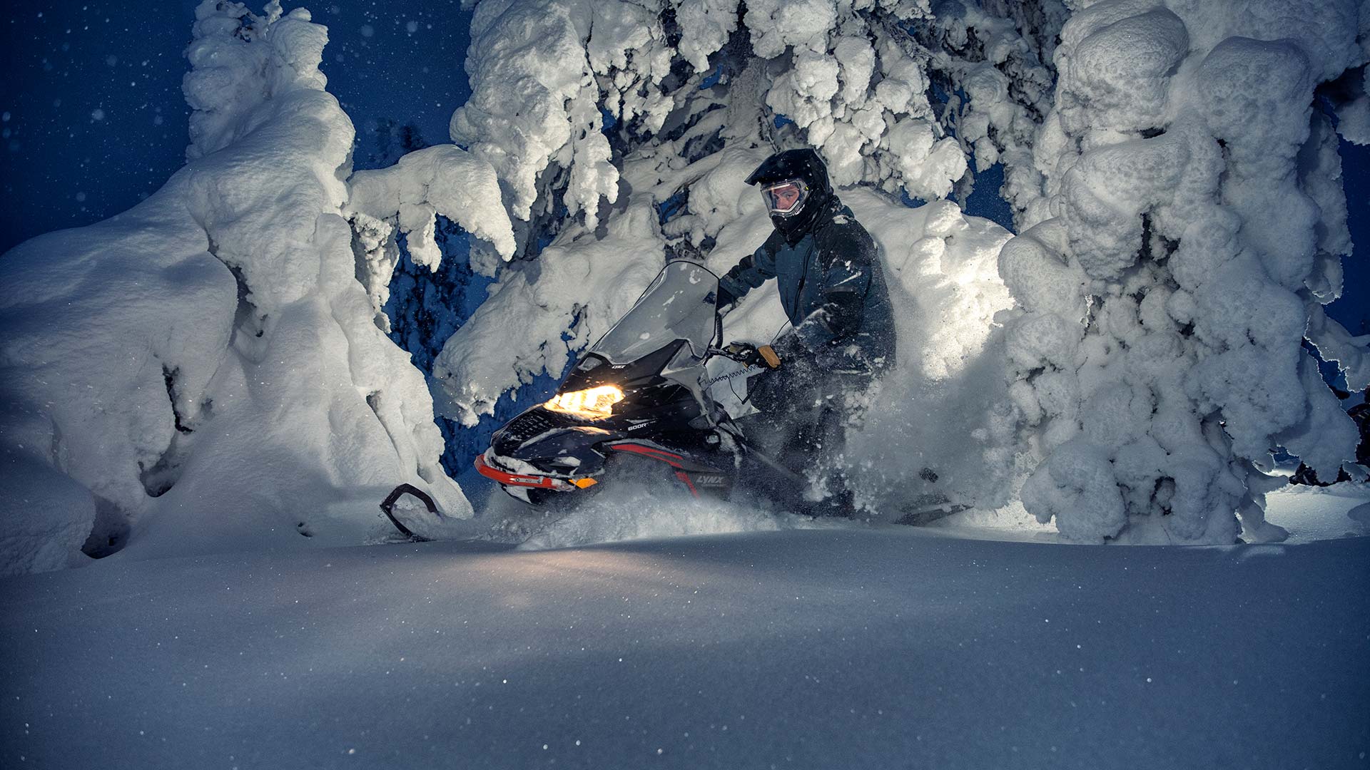 Lynx Commander snowmobile riding in Arctic snowy forest
