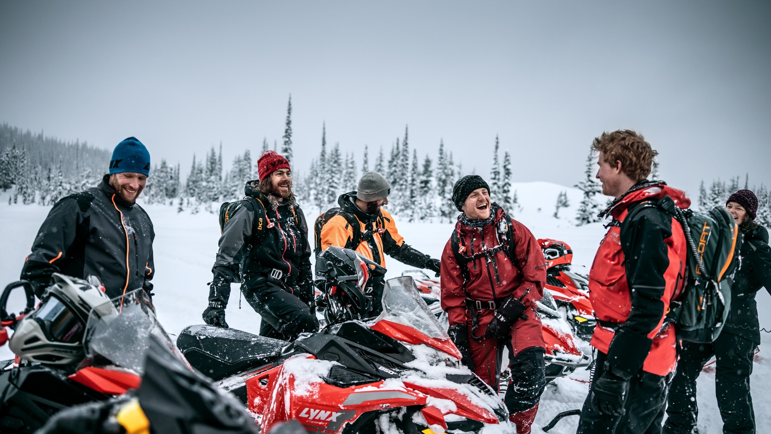 Group of friends sharing a good moment during a snowmobile ride