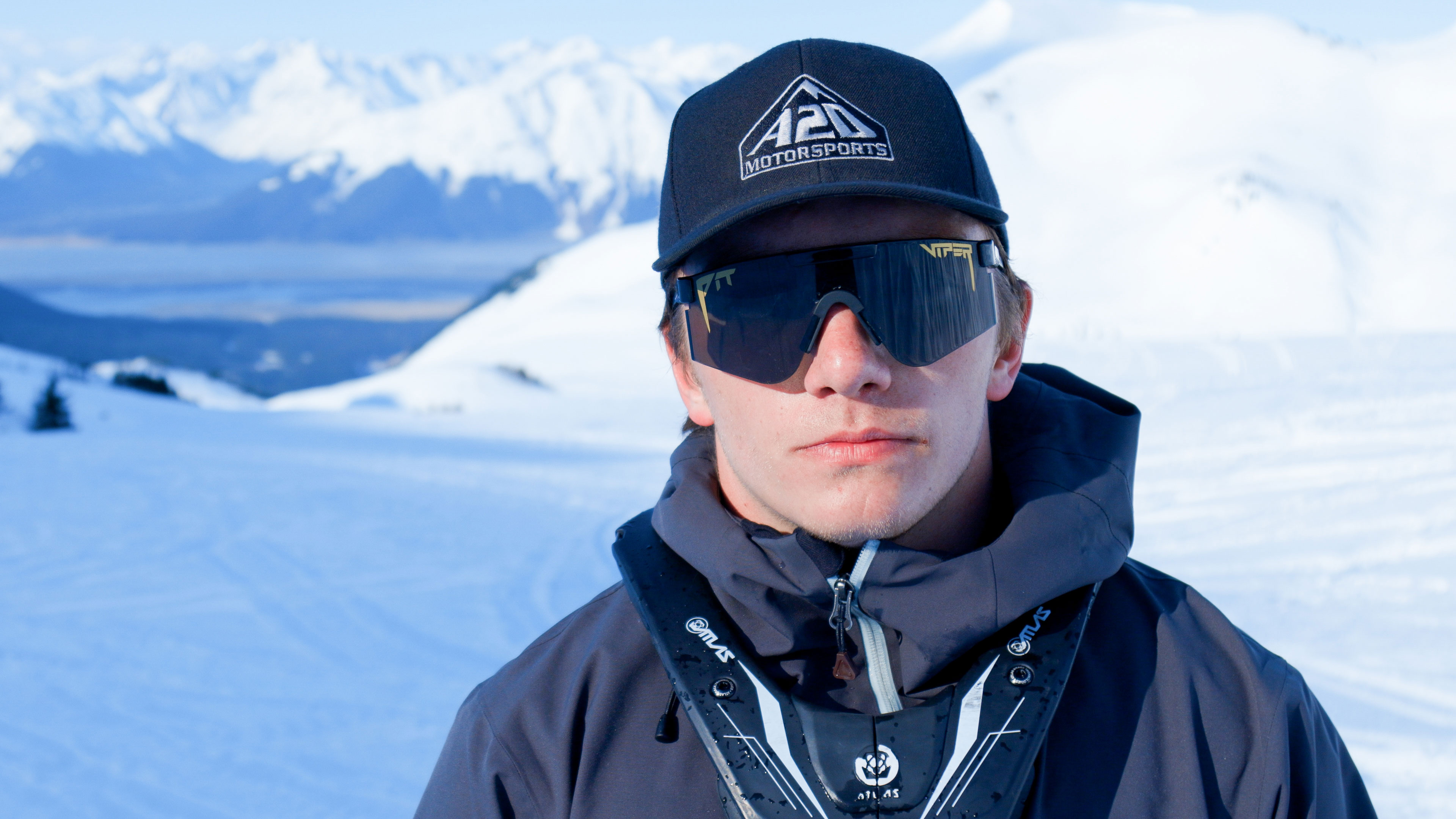 Warren Gage standing on a Lynx snowmobile