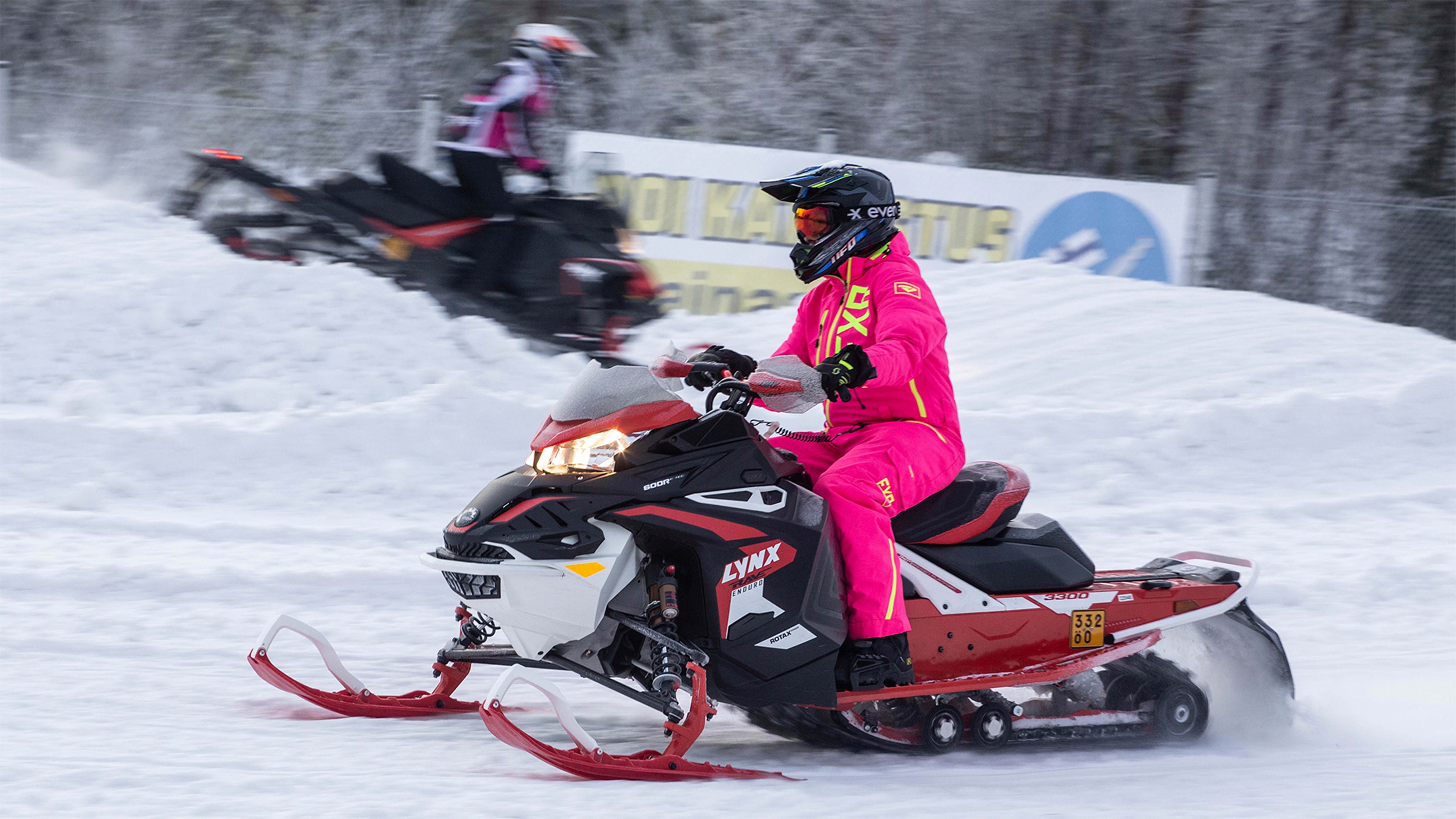 Two snowobiles riding on a training track