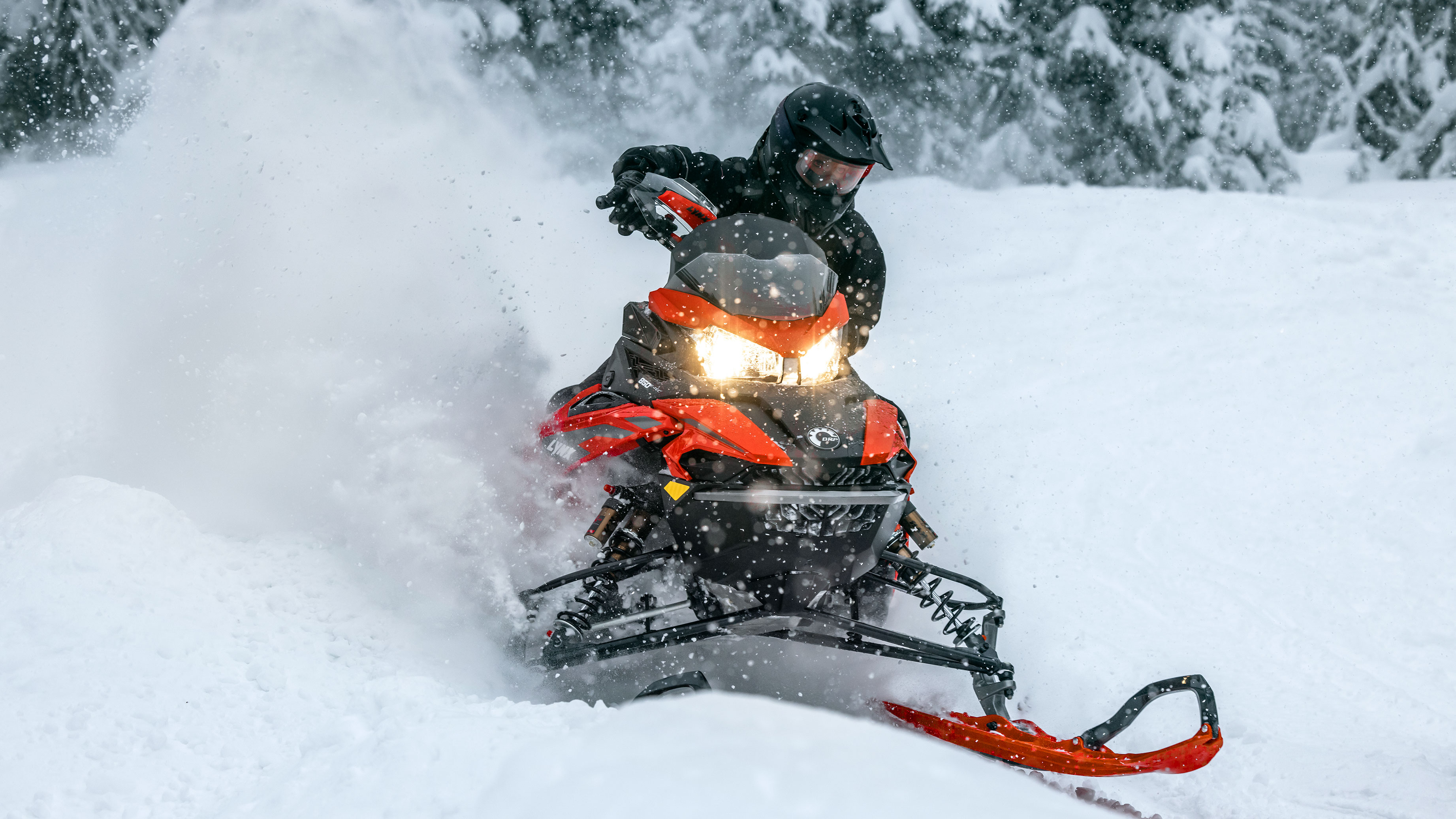 Rider blowing some snow on their 2023 Lynx snowmobile