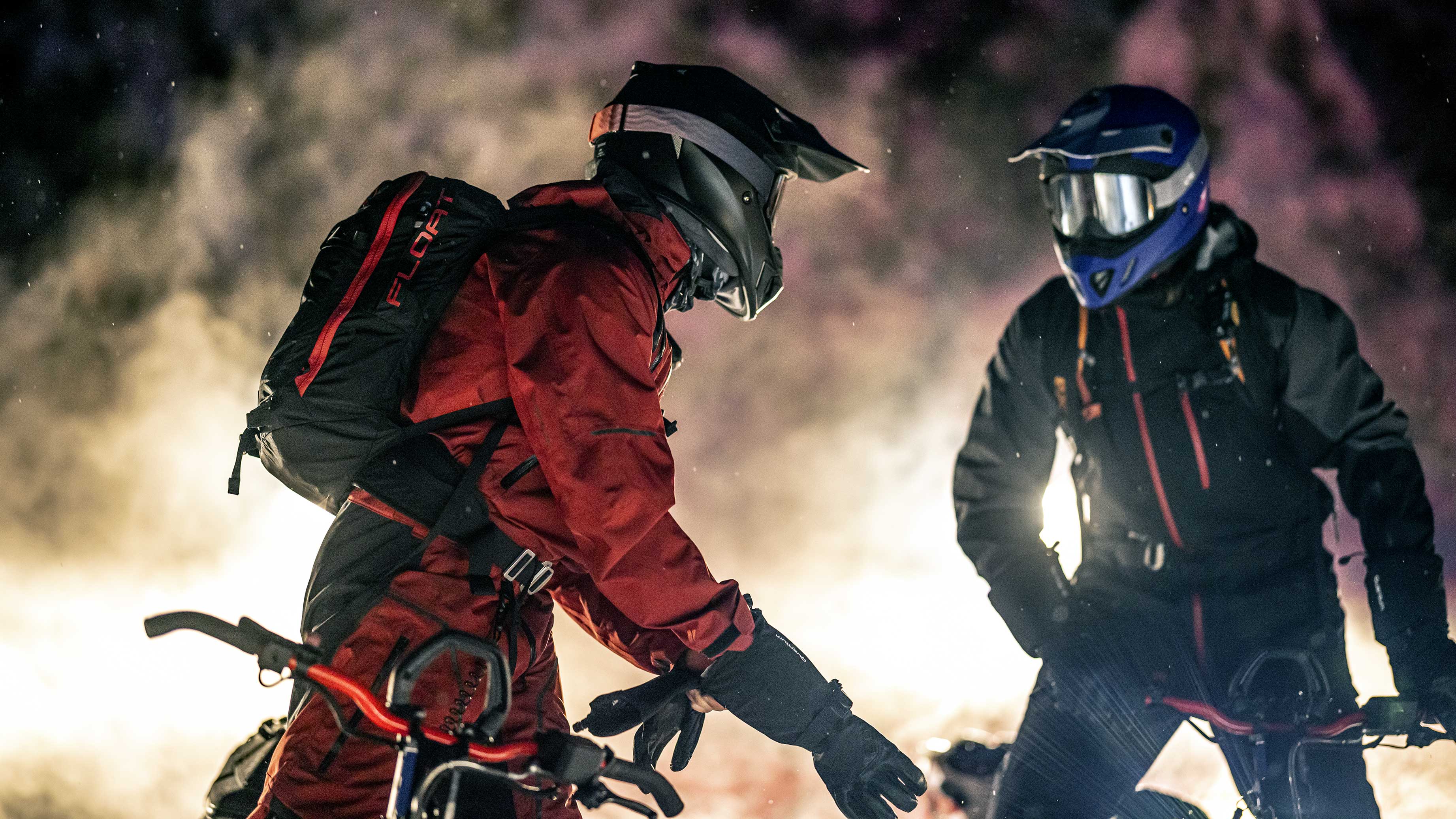 Two riders are preparing for a ride and chatting together