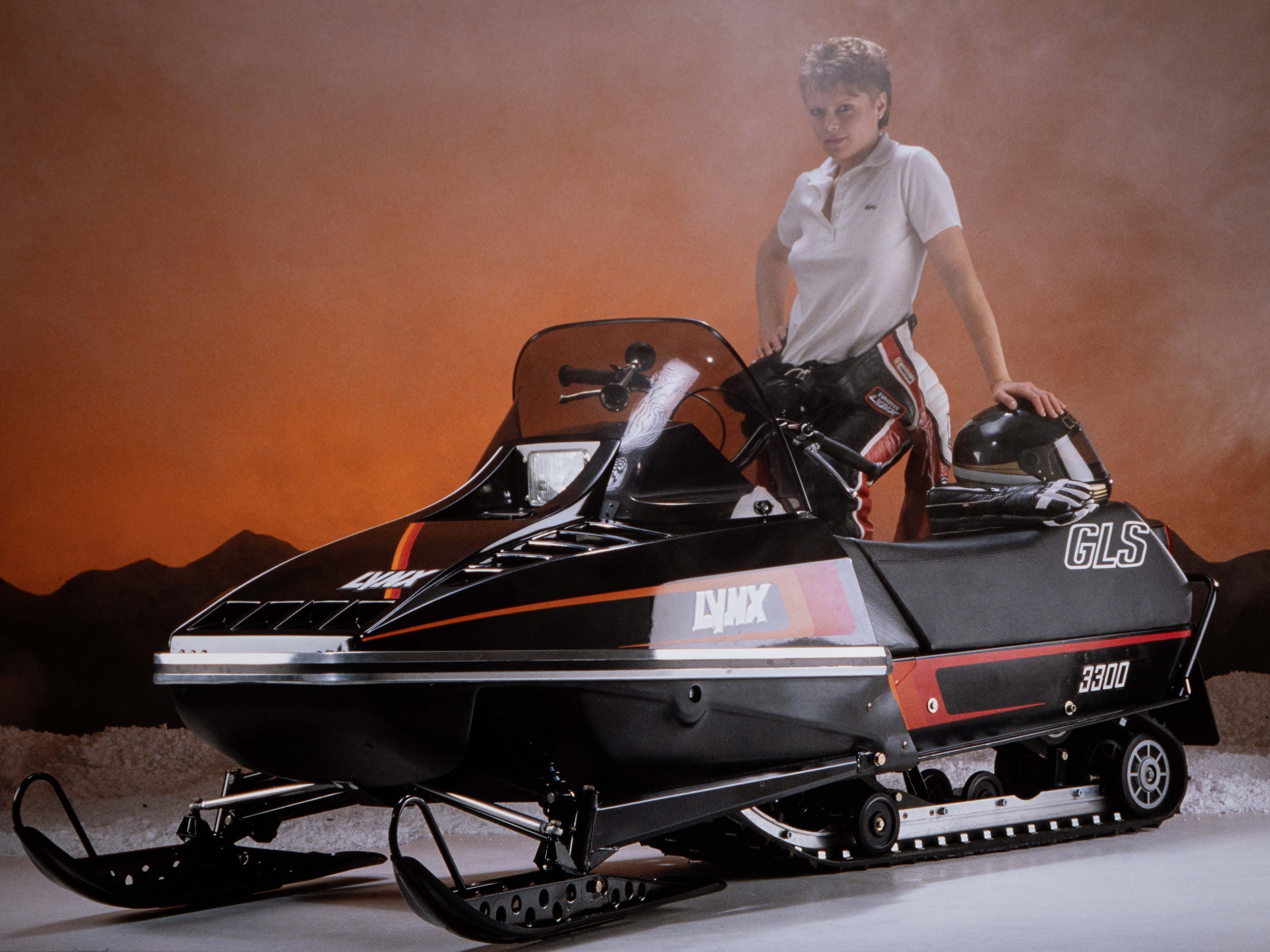 Woman posing in studio with Lynx GLS 3300 1985 snowmobile