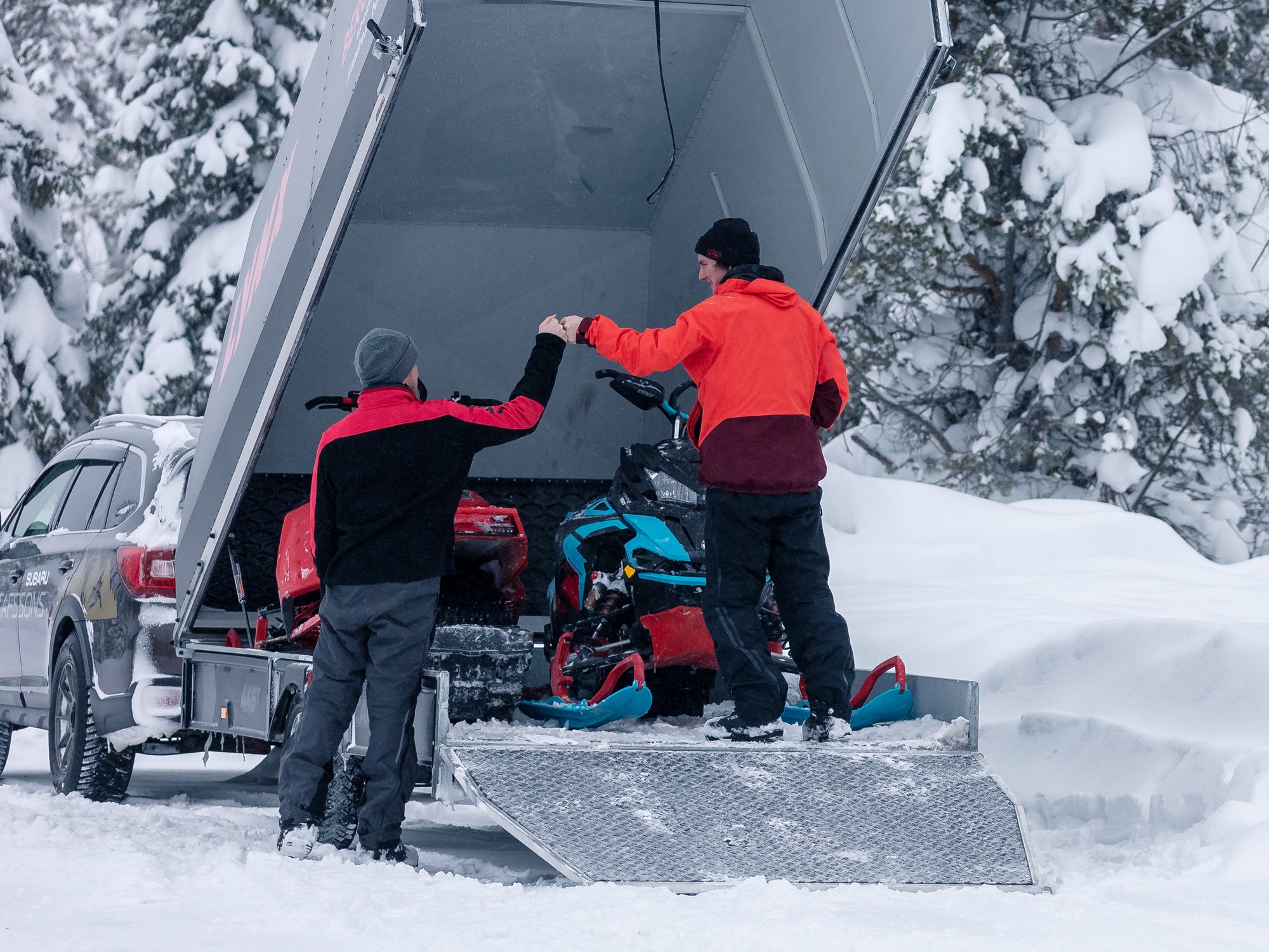 Two Lynx Riders and Snowmobiles in a trailer
