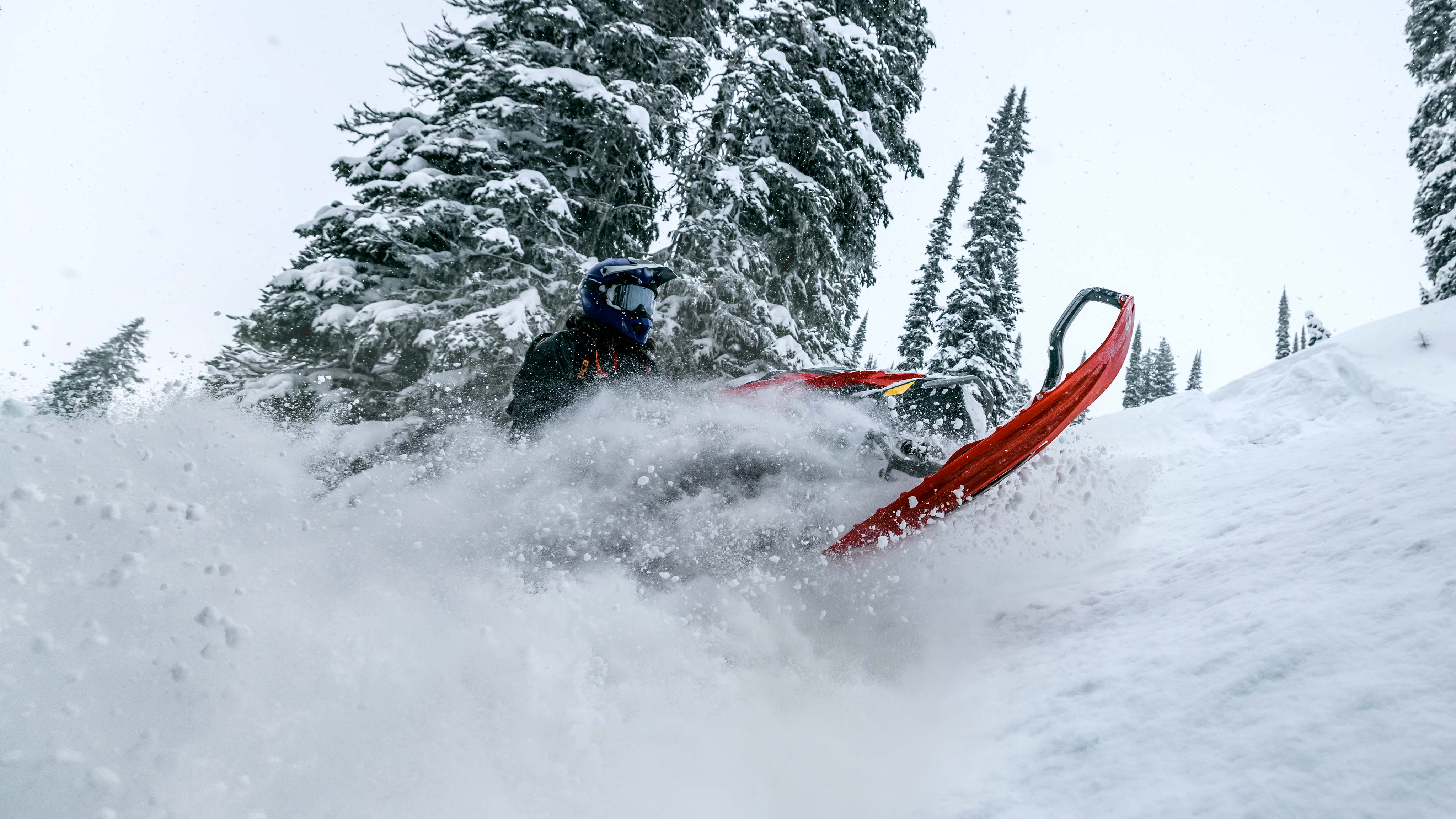 Jason Ribi driving his Lynx Shredder in deep powder