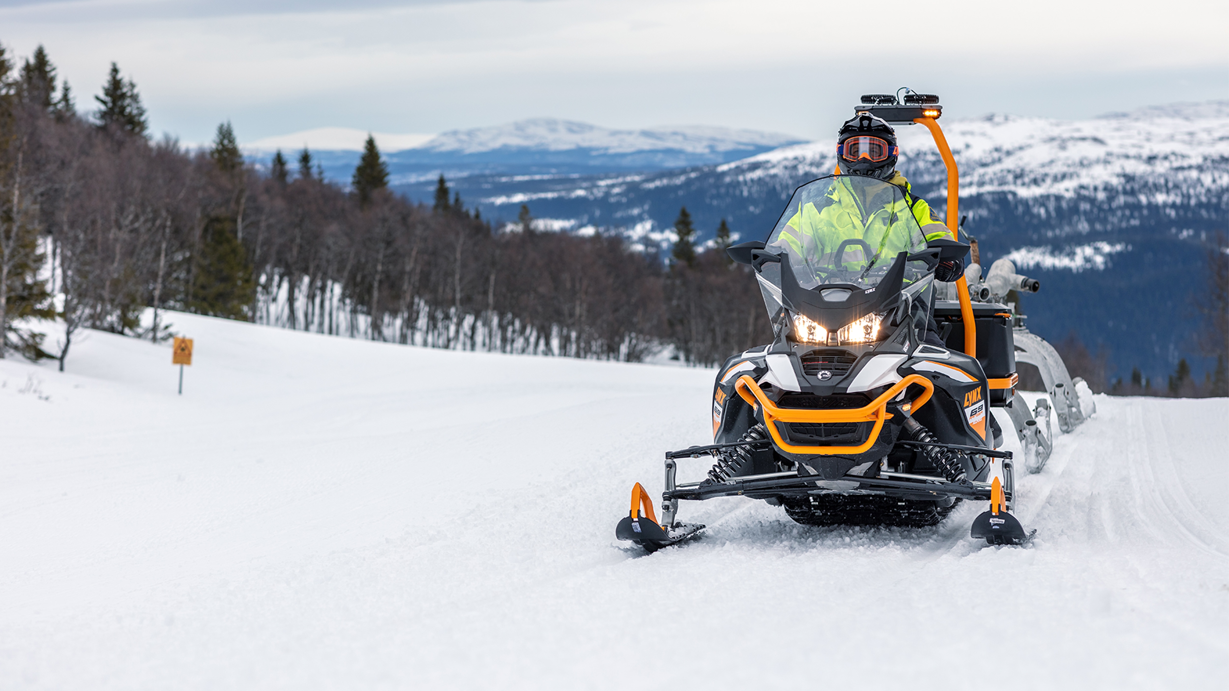 Snežný skúter Lynx 69 Ranger Alpine pri ťahacích prácach v ski-rezorte