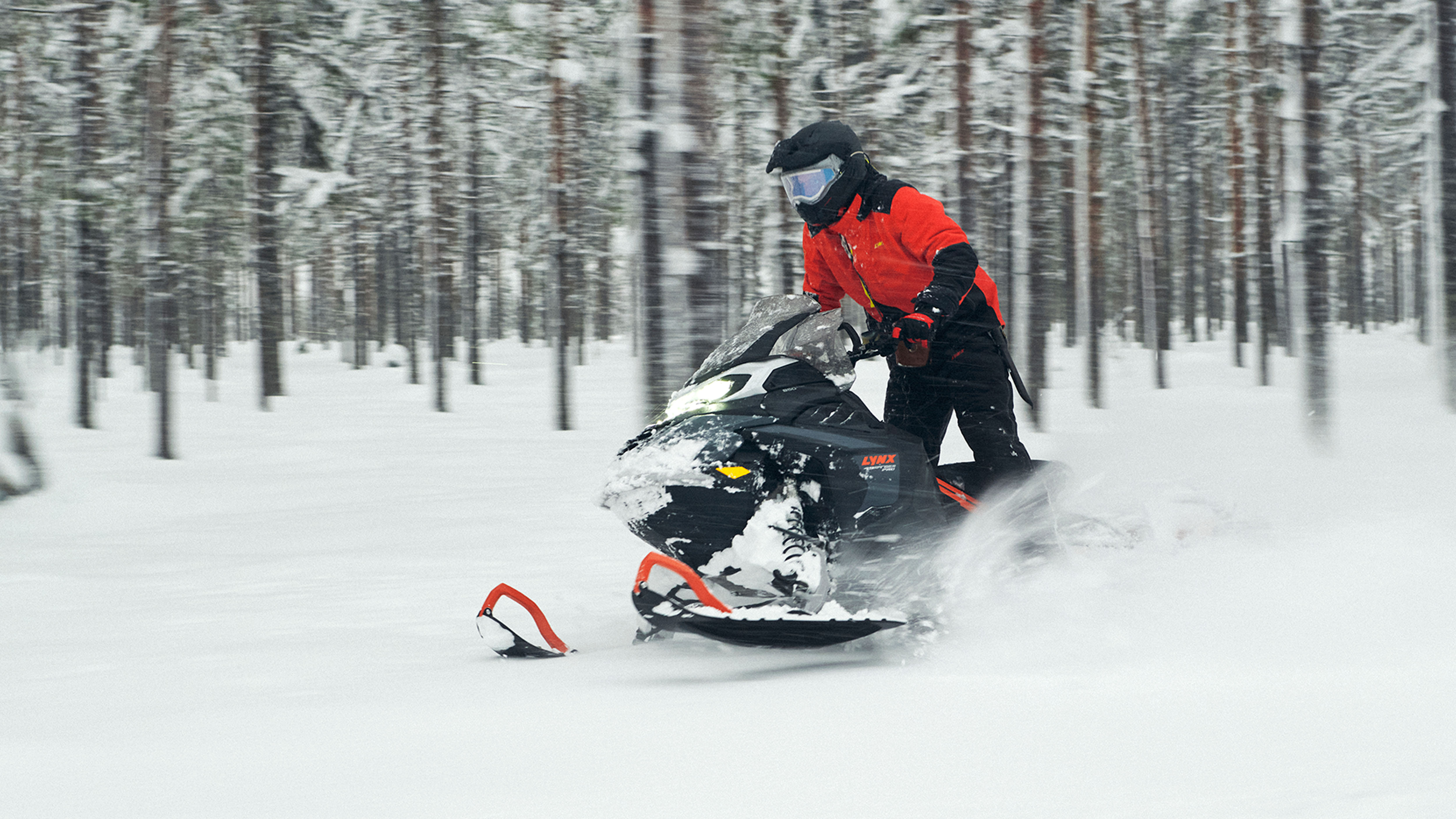 Lynx 49 Ranger PRO snowmobile riding in snowy forest