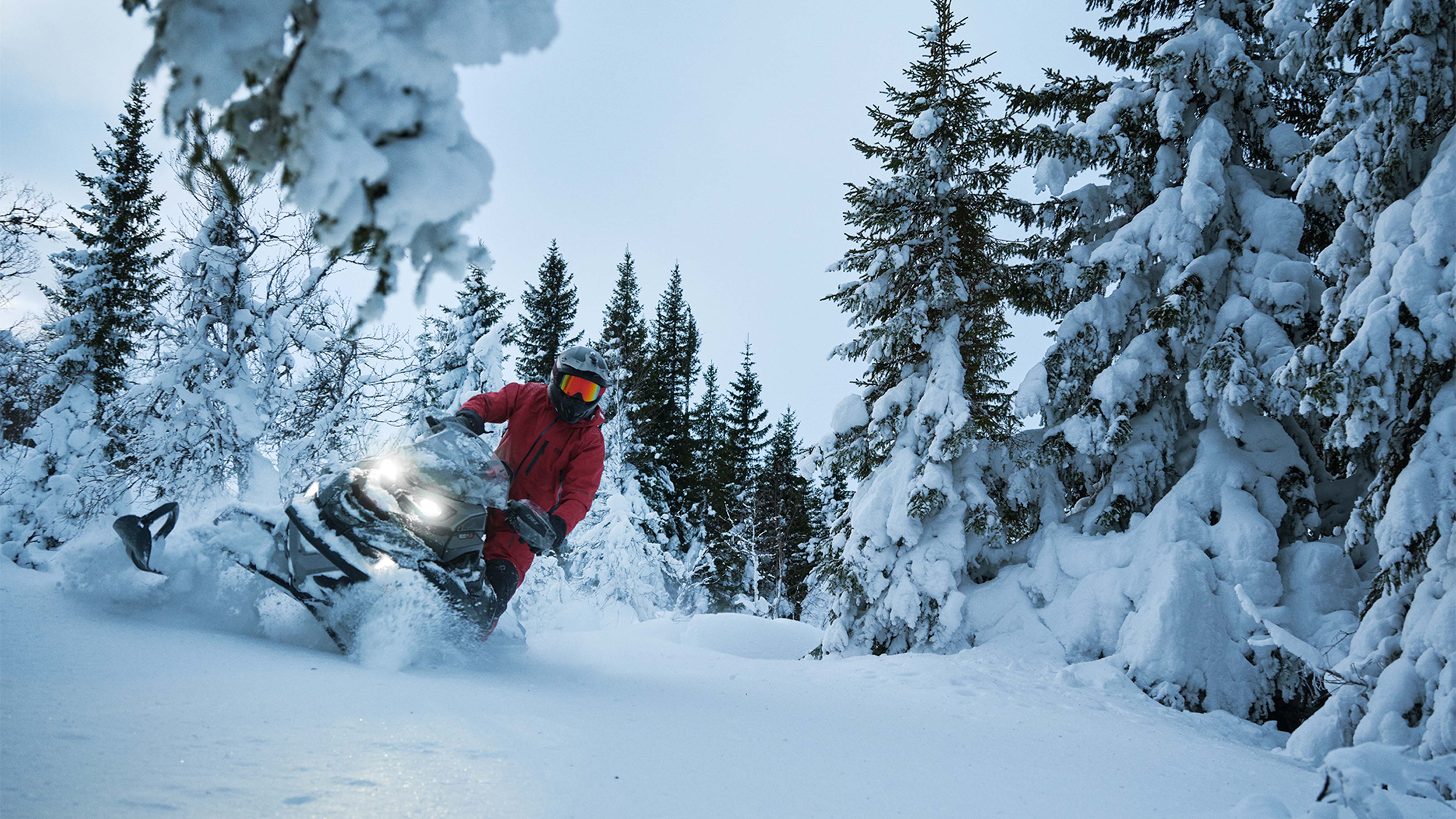 Lynx Brutal RE 2025 snowmobile curving in the snowy forest