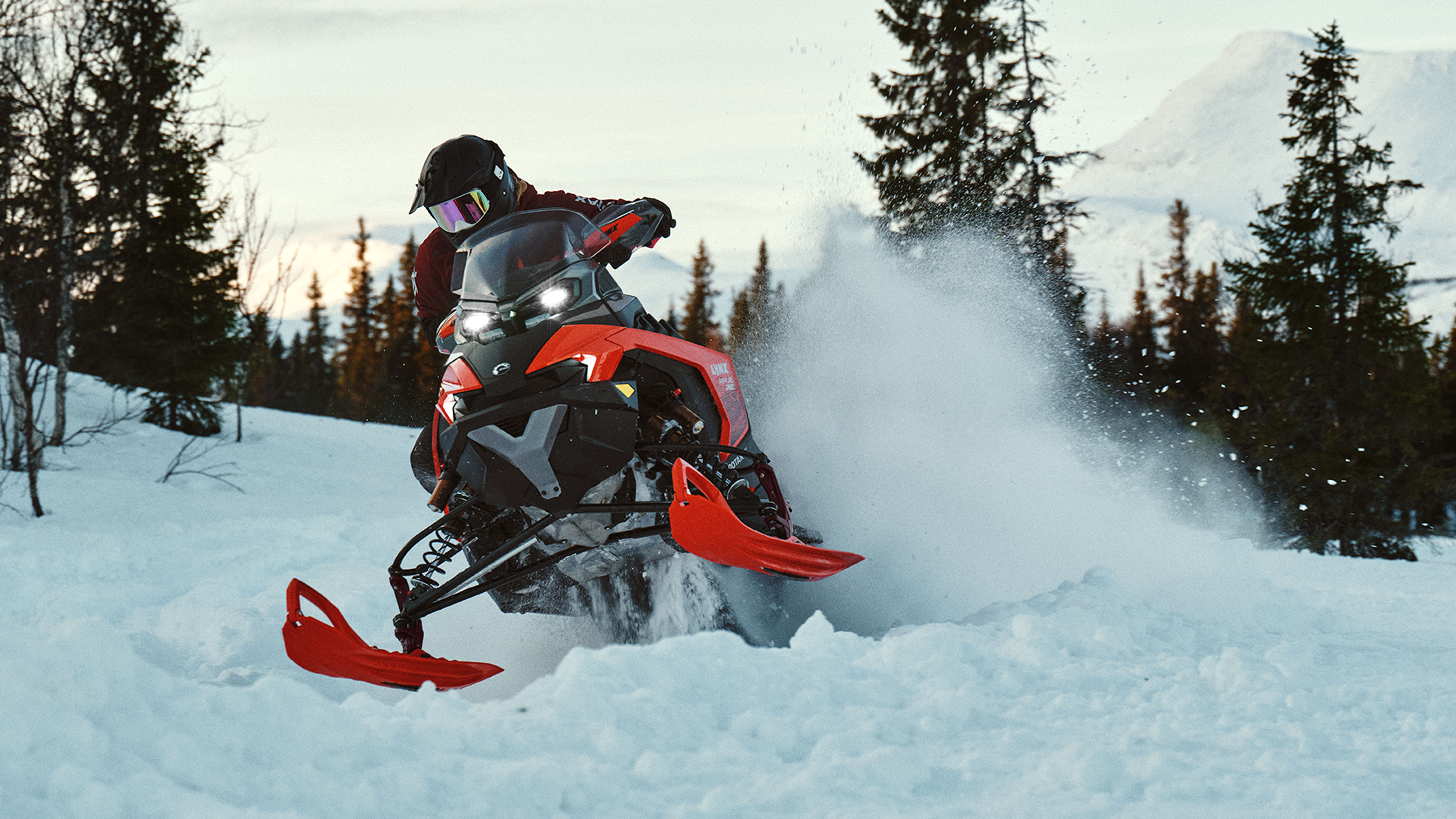 Lynx Rave RE 2025 snowmobile cornering on bumpy trail