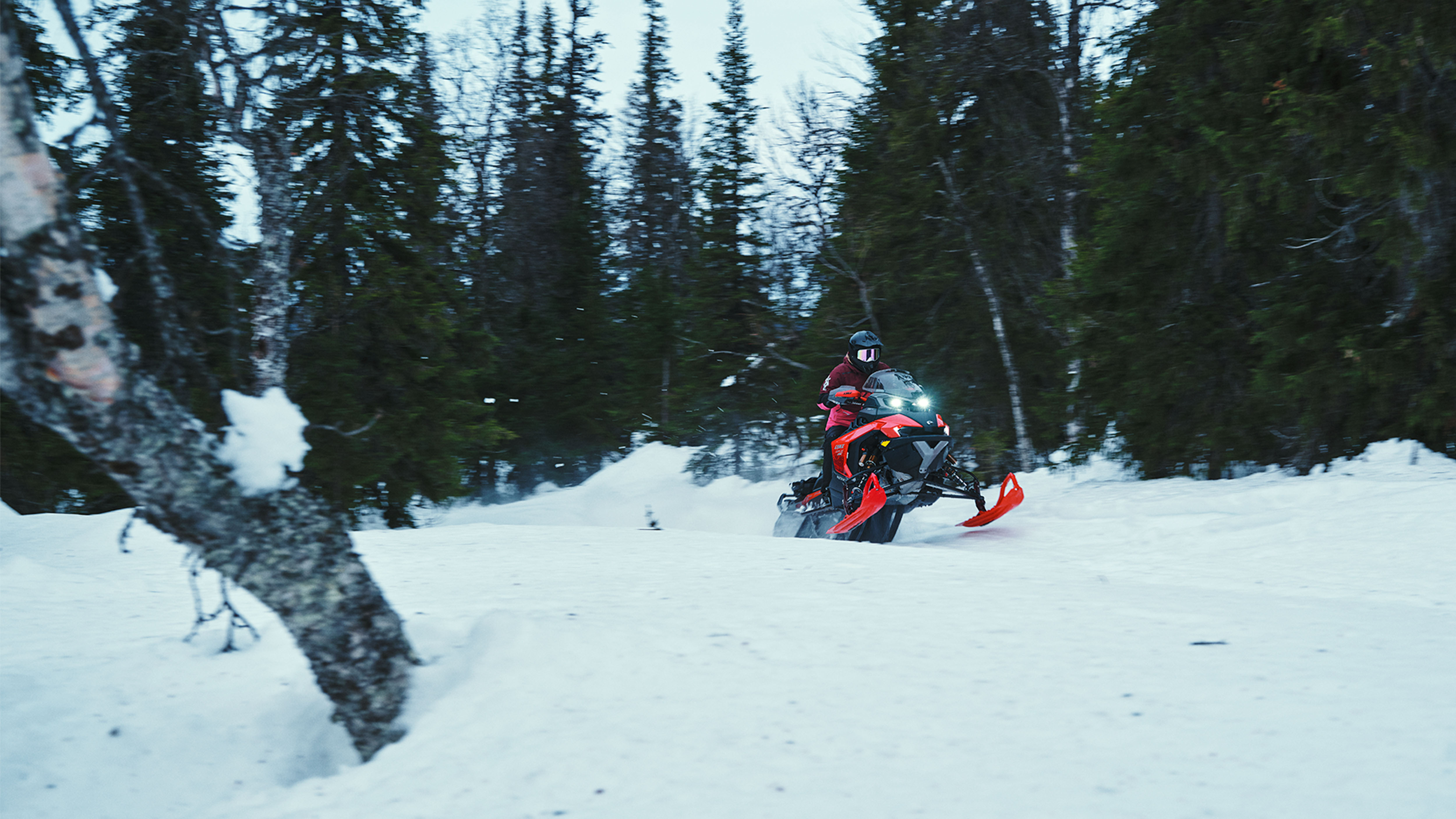 Lynx Rave RE 2025 snowmobile accelerating on trail
