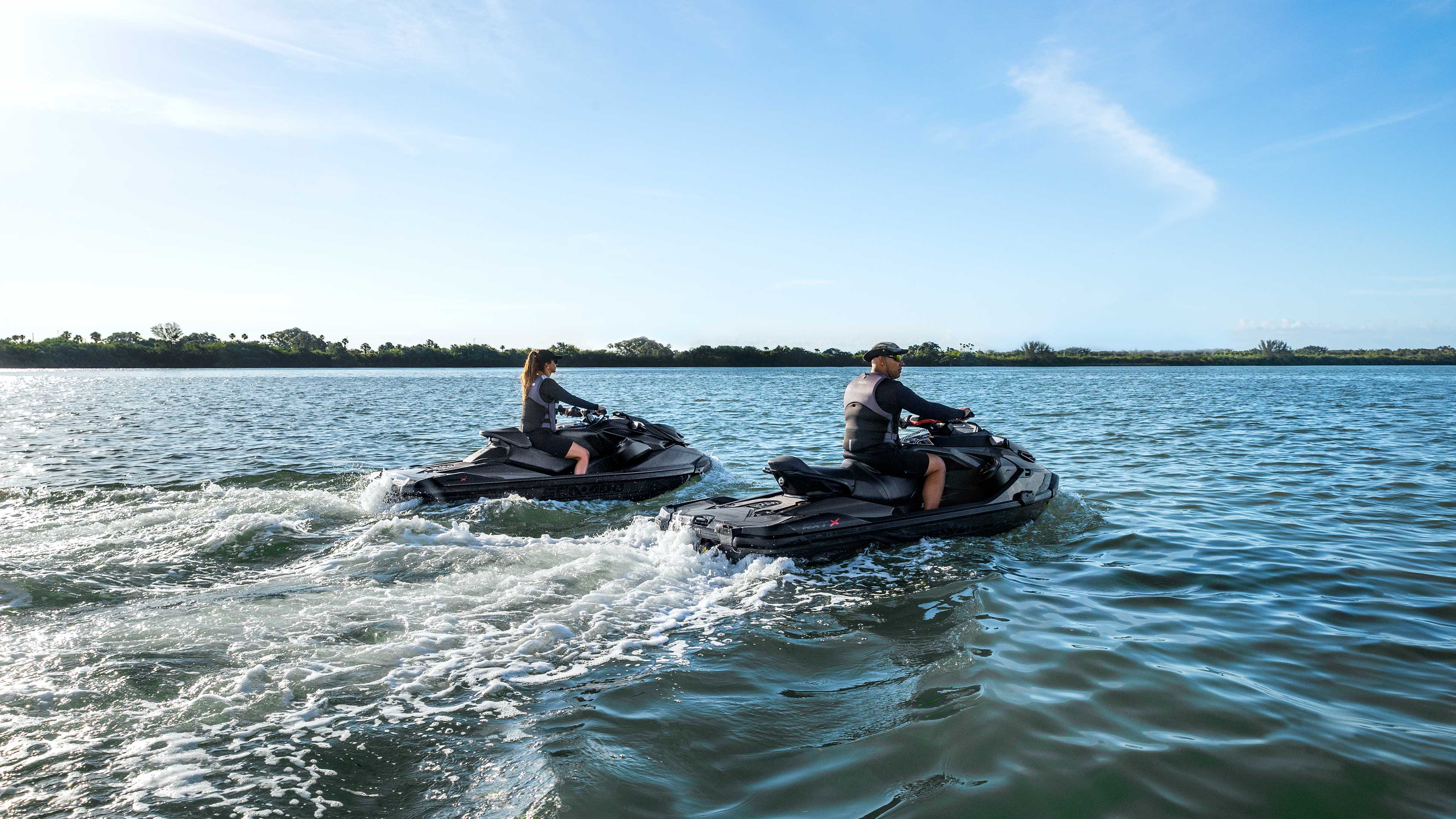 Man and woman riding a Sea-Doo RXP-X