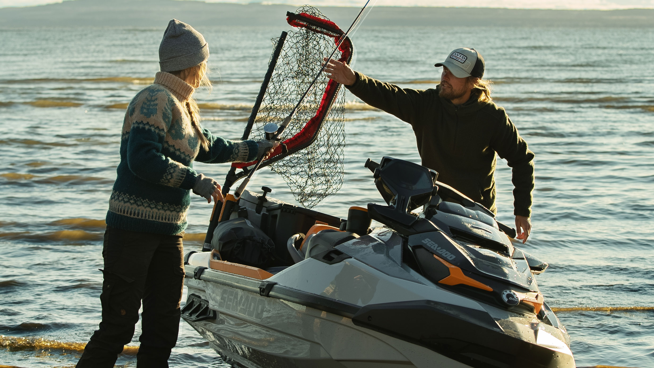 Matilda and her boyfriend riding Sea-Doo FishPro watercrafts at sunset