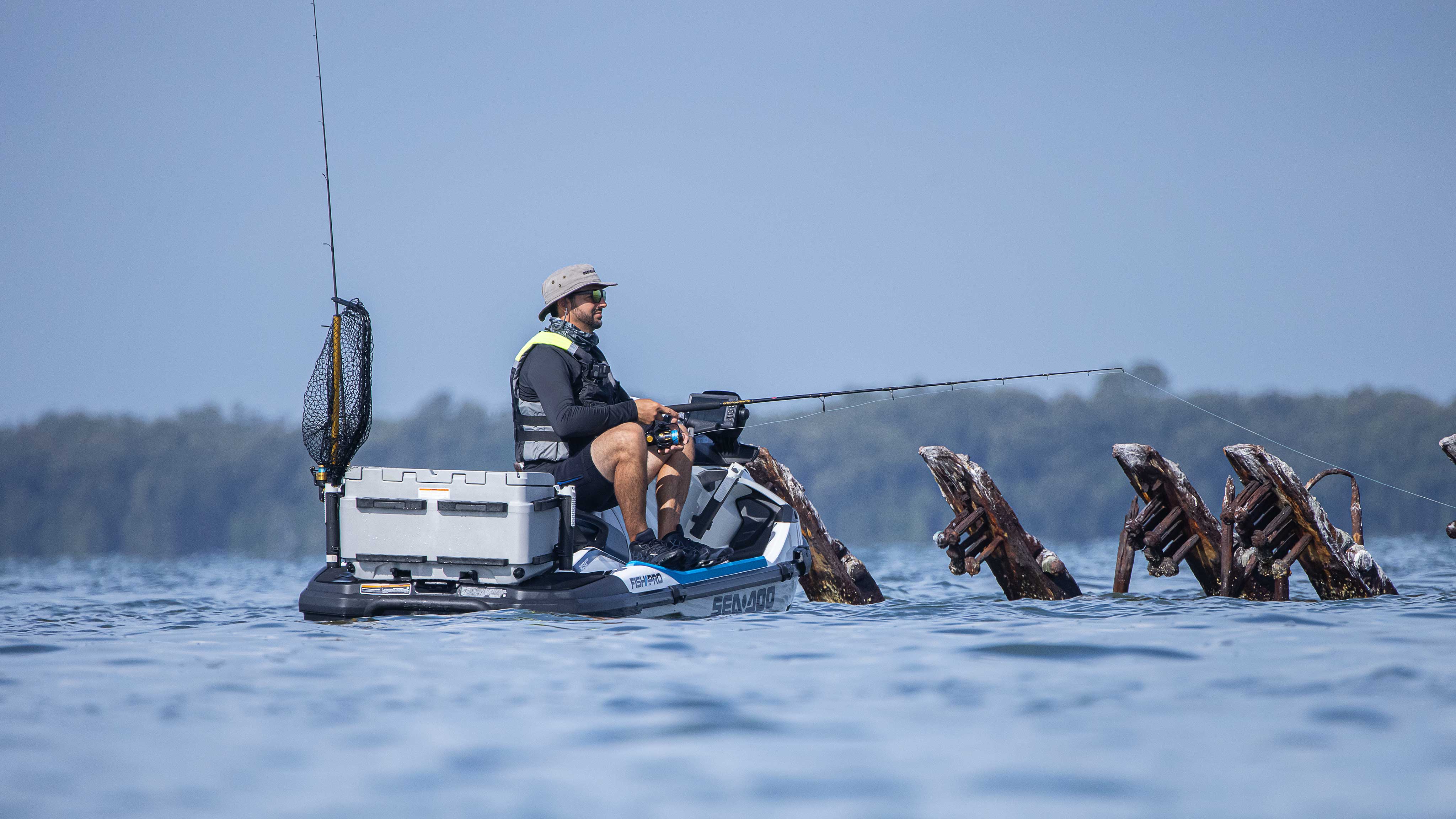 Man fishing while sitting on his Sea-Doo FishPro Sport