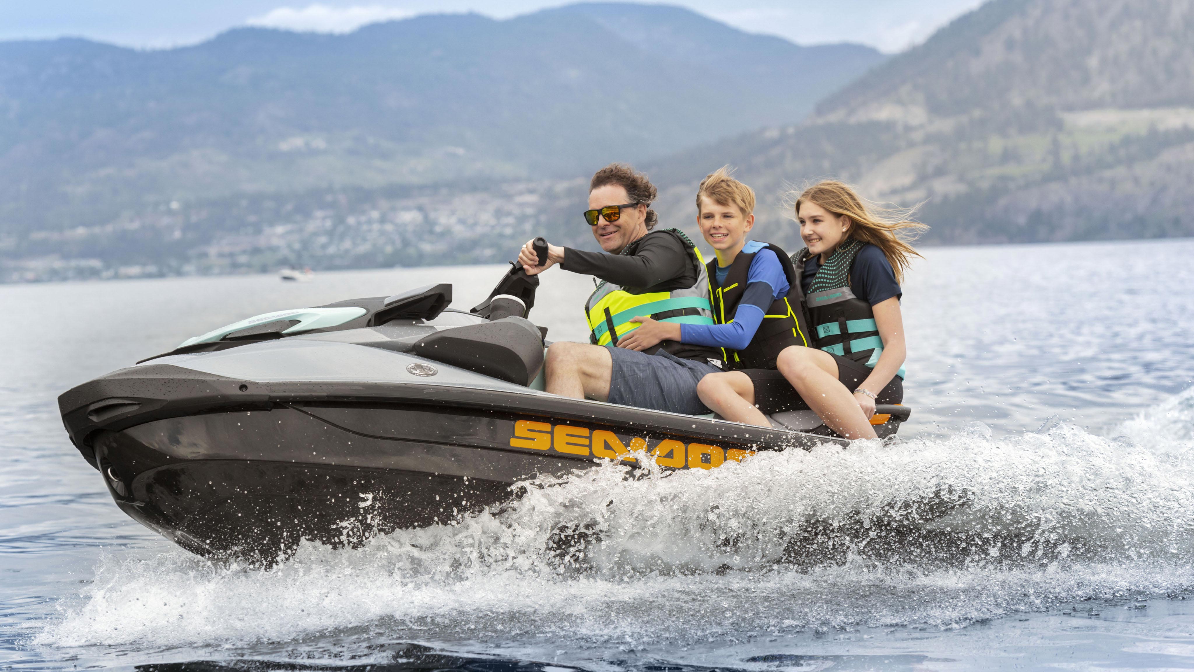 A dad and his two kids on the Sea-Doo GTI SE