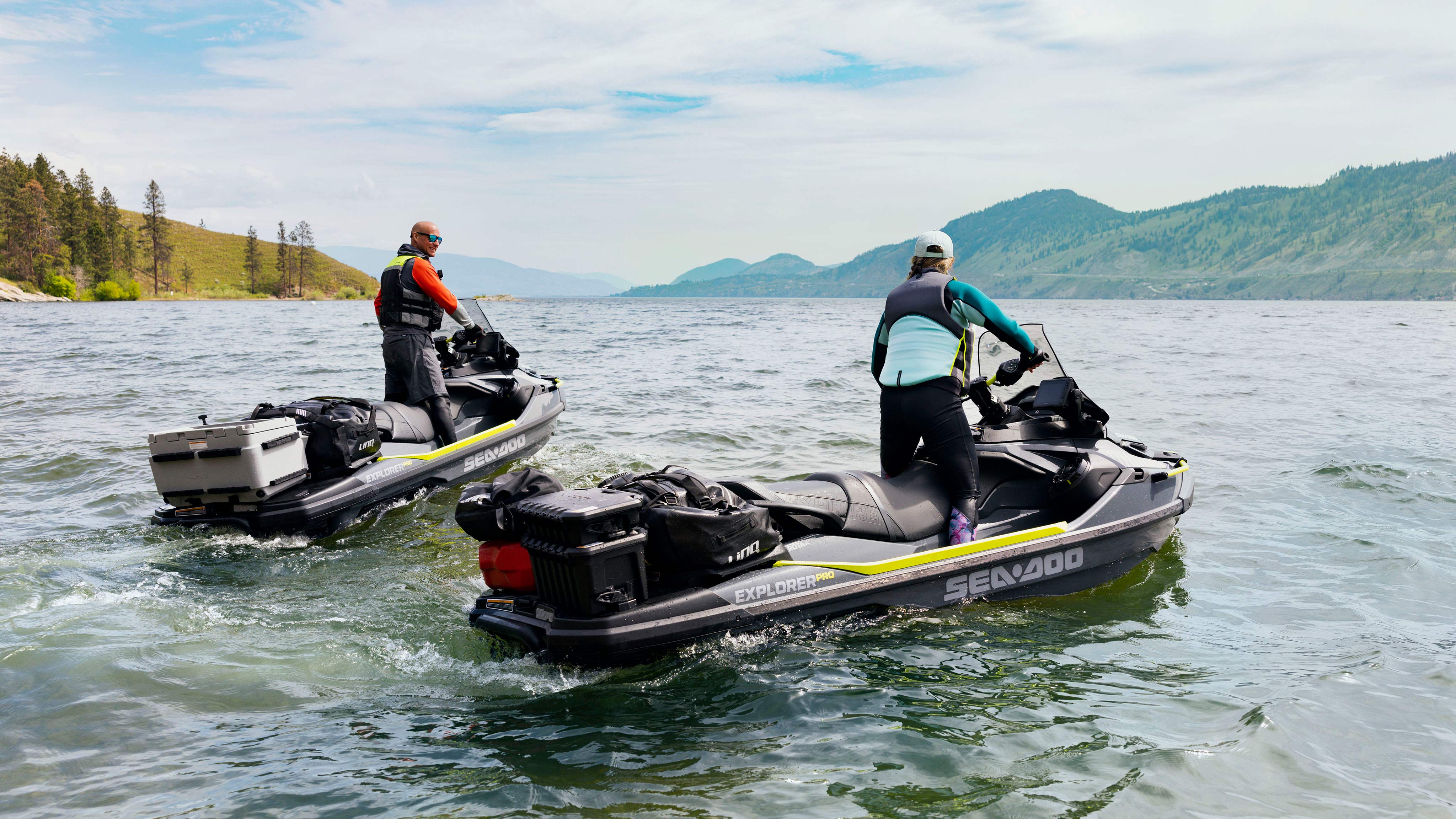 Two people riding their Sea-Doo Explorer Pro with LinQ Accessories