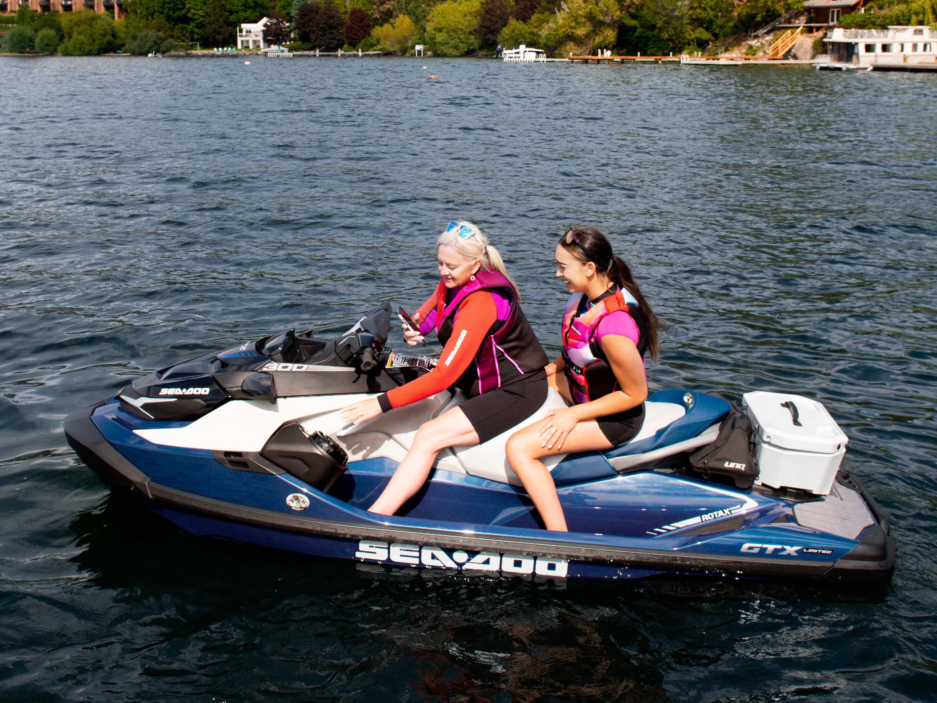 A mom and her daughter using the audio system on the Sea-Doo GTX Limited