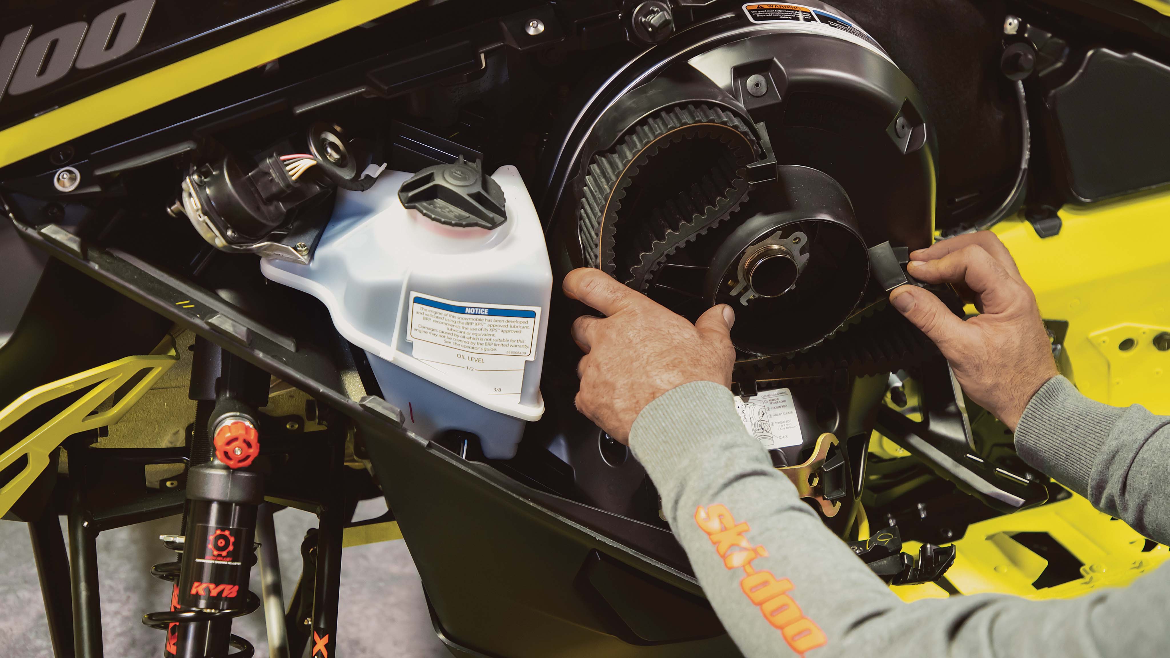 Ski-Doo owner adjusting the drive belt on Ski-Doo Rotax engine