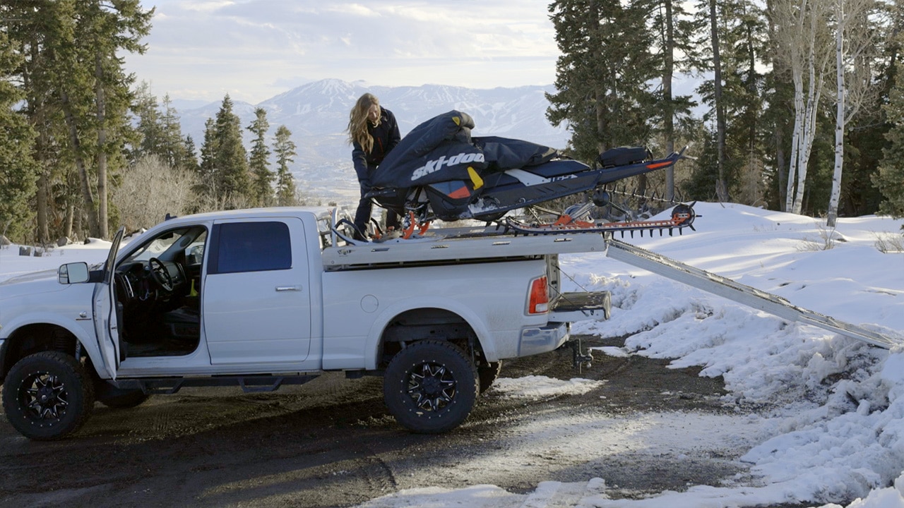 Stefanie Dean adding a cover to her sled that was loaded to her truck