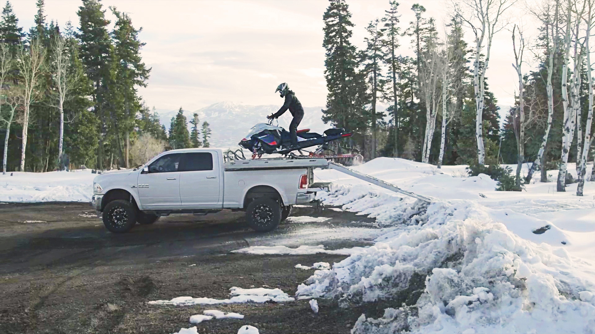 Stefanie Dean loading a Ski-Doo for transportation