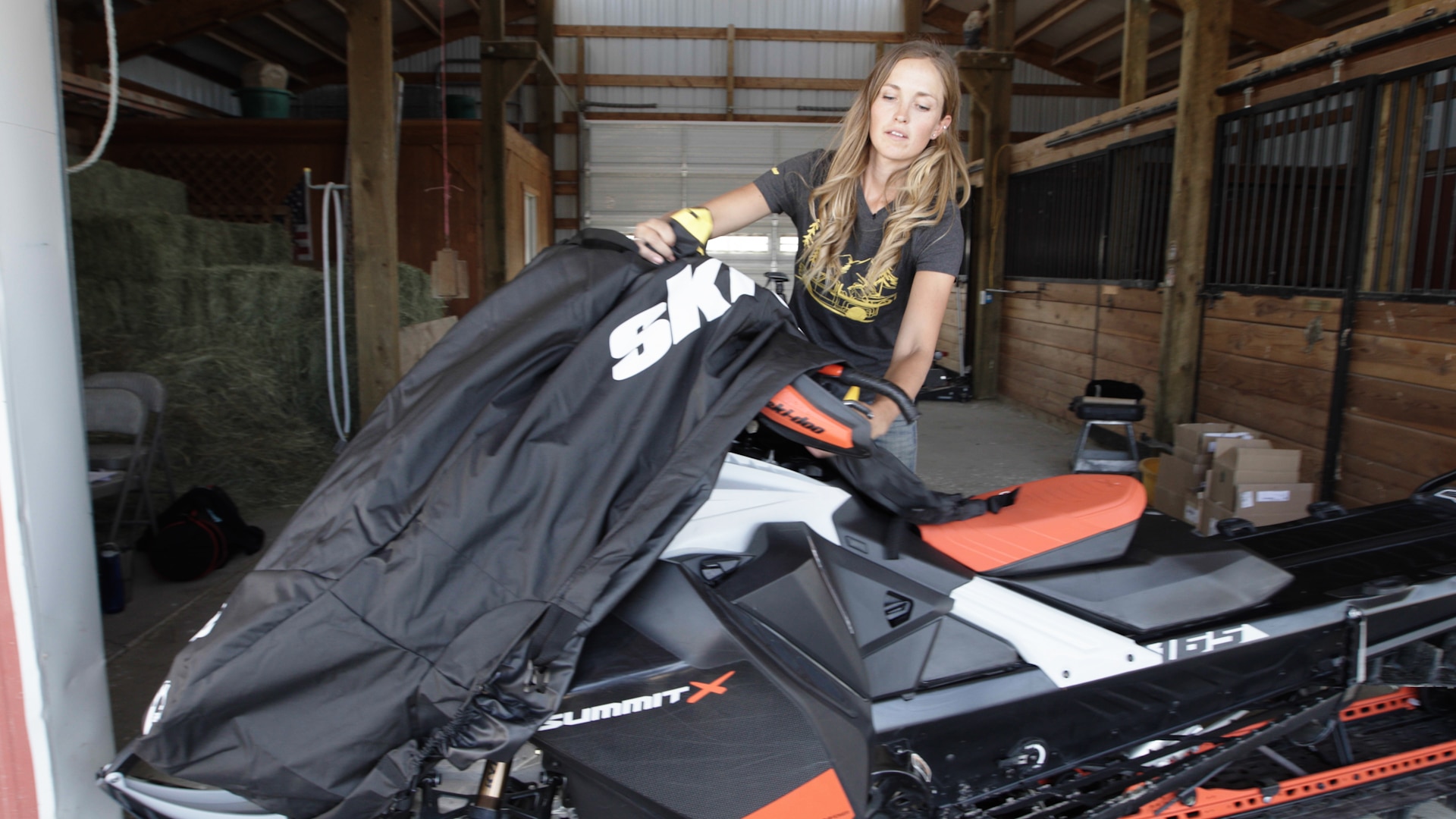 Stefanie Dean covering her Ski-Doo snowmobile for Summer storage
