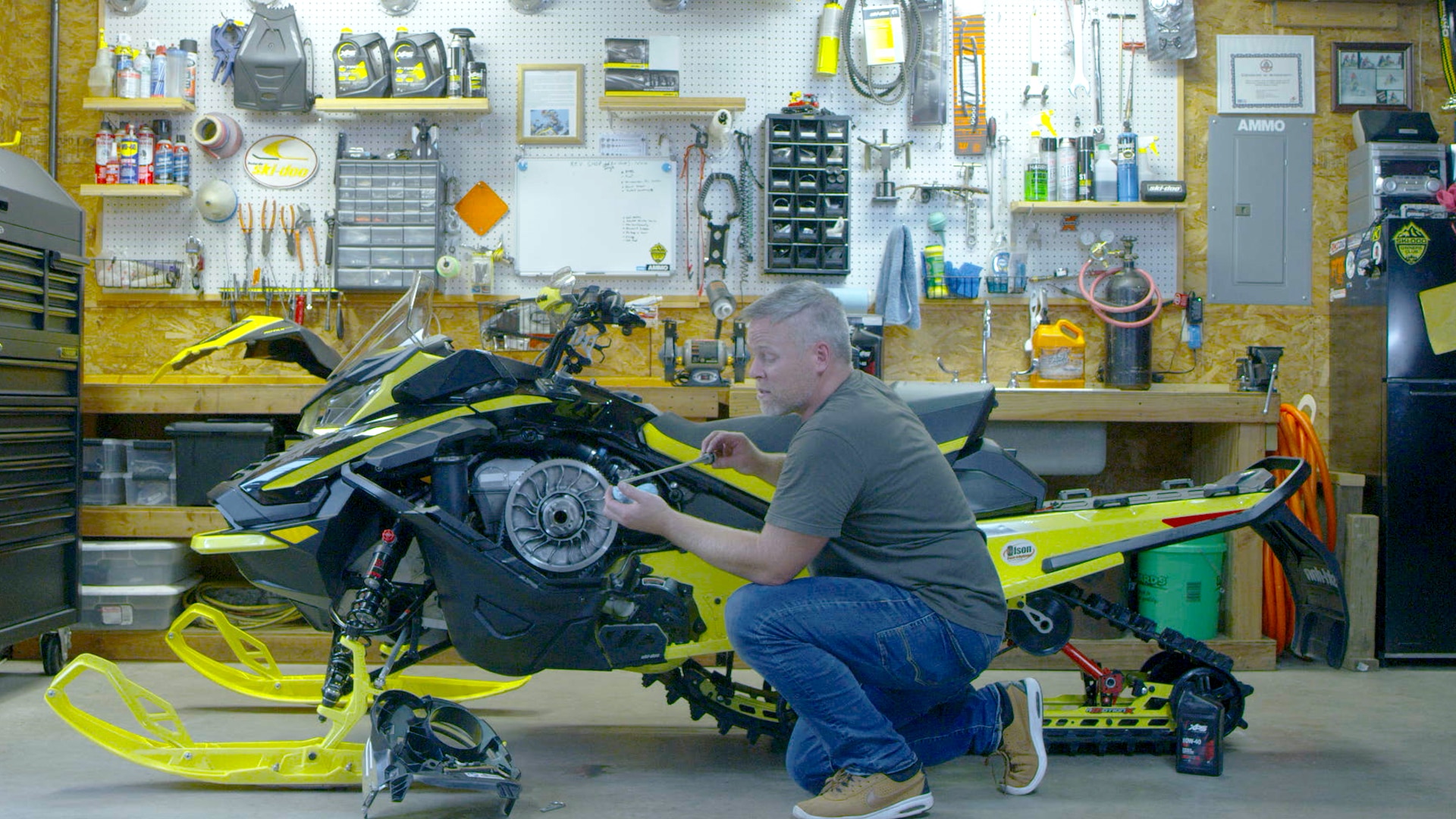 Ski-doo ambassador Troy Oleson doing maintenance on his sled