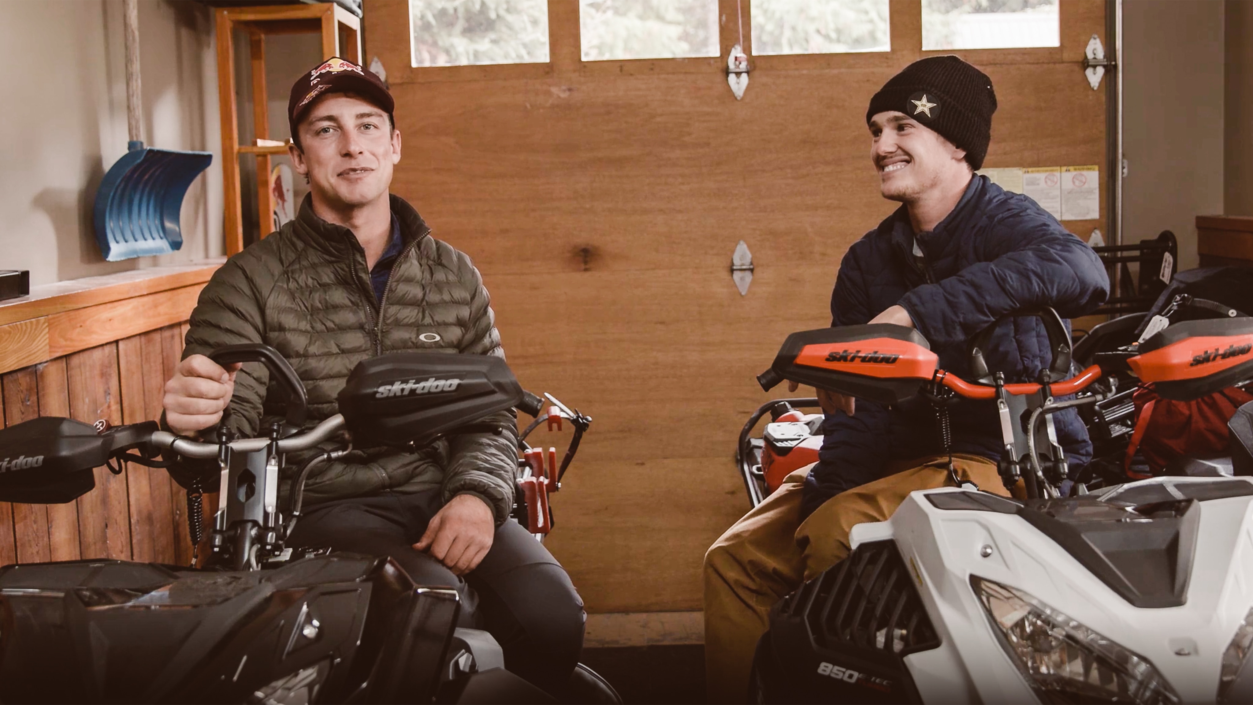 Ski-Doo Ambassador Craig McMorris siiting on his snowmobile in a garage