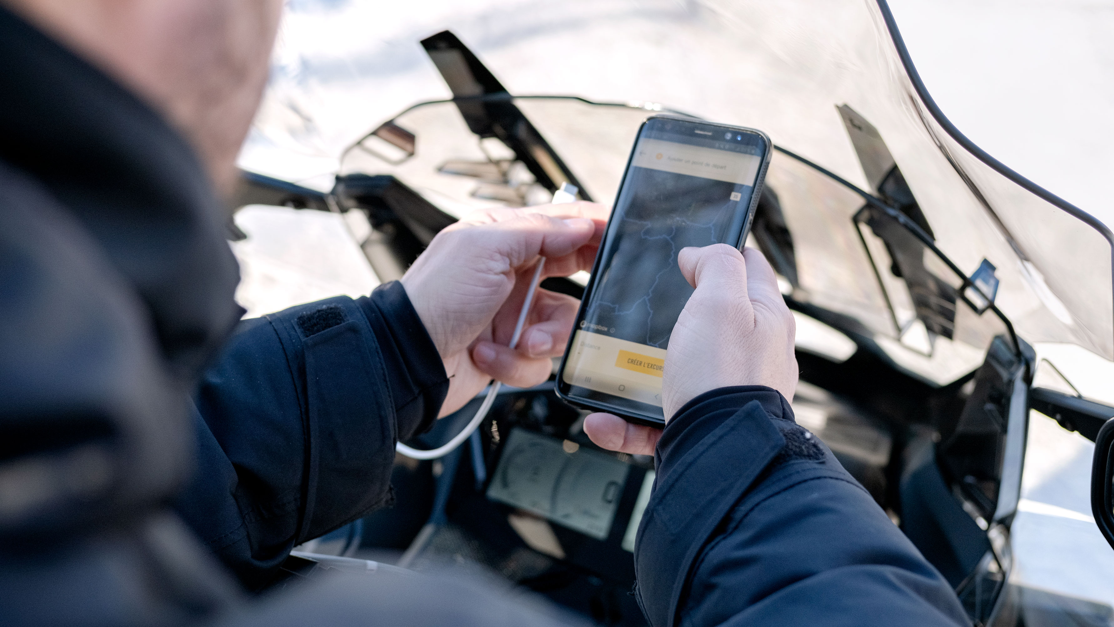 Man using BRP GO! App with his Ski-Doo snowmobile