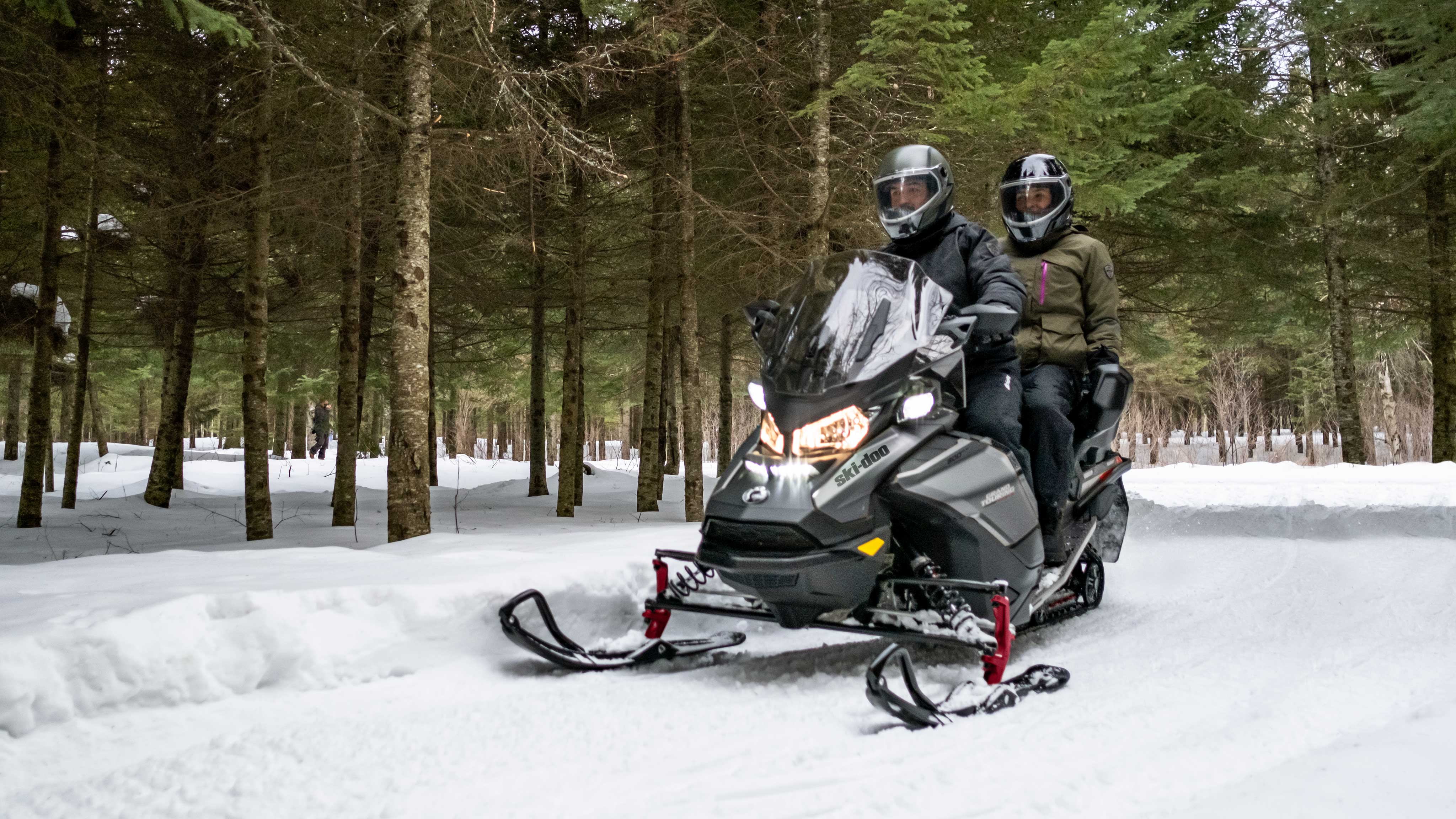 Couple enjoying a ride on a Ski-Doo Grand Touring