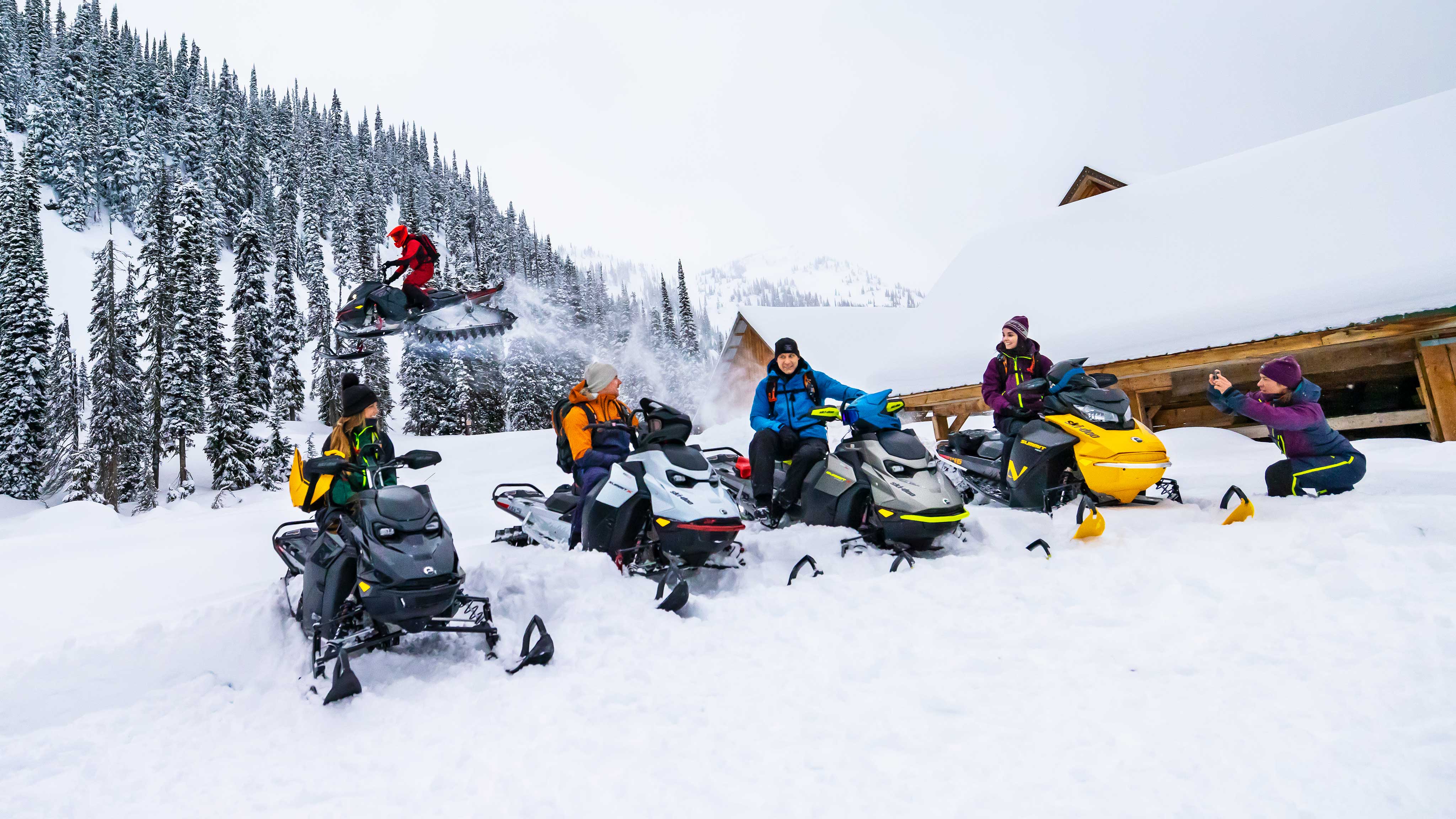 Bir grup arkadaş, Ski-Doo kar motosikletleriyle karda bir günün tadını çıkarıyor.