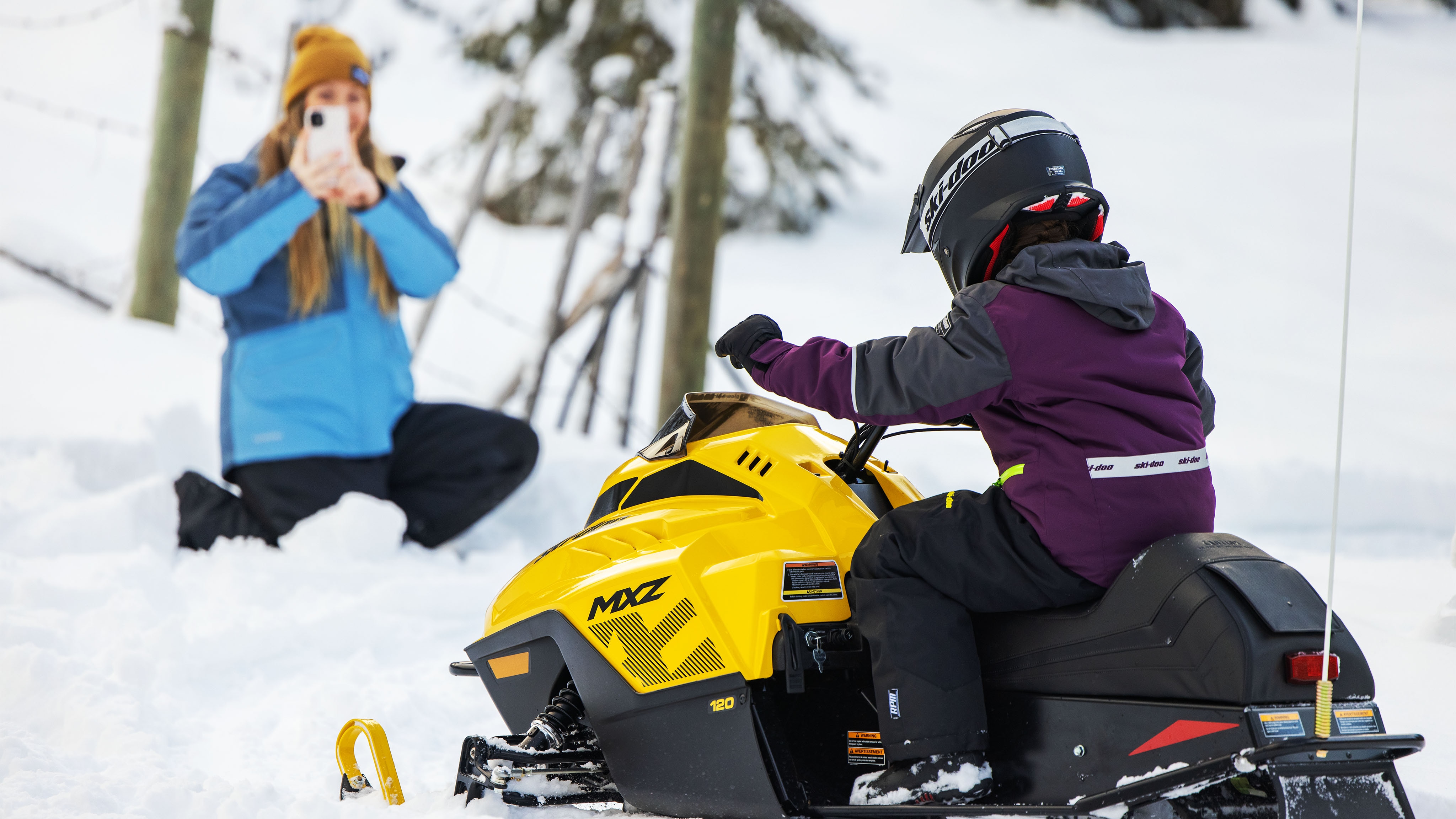 Girl having fun with her snowmobile Ski-Doo MXZ 120