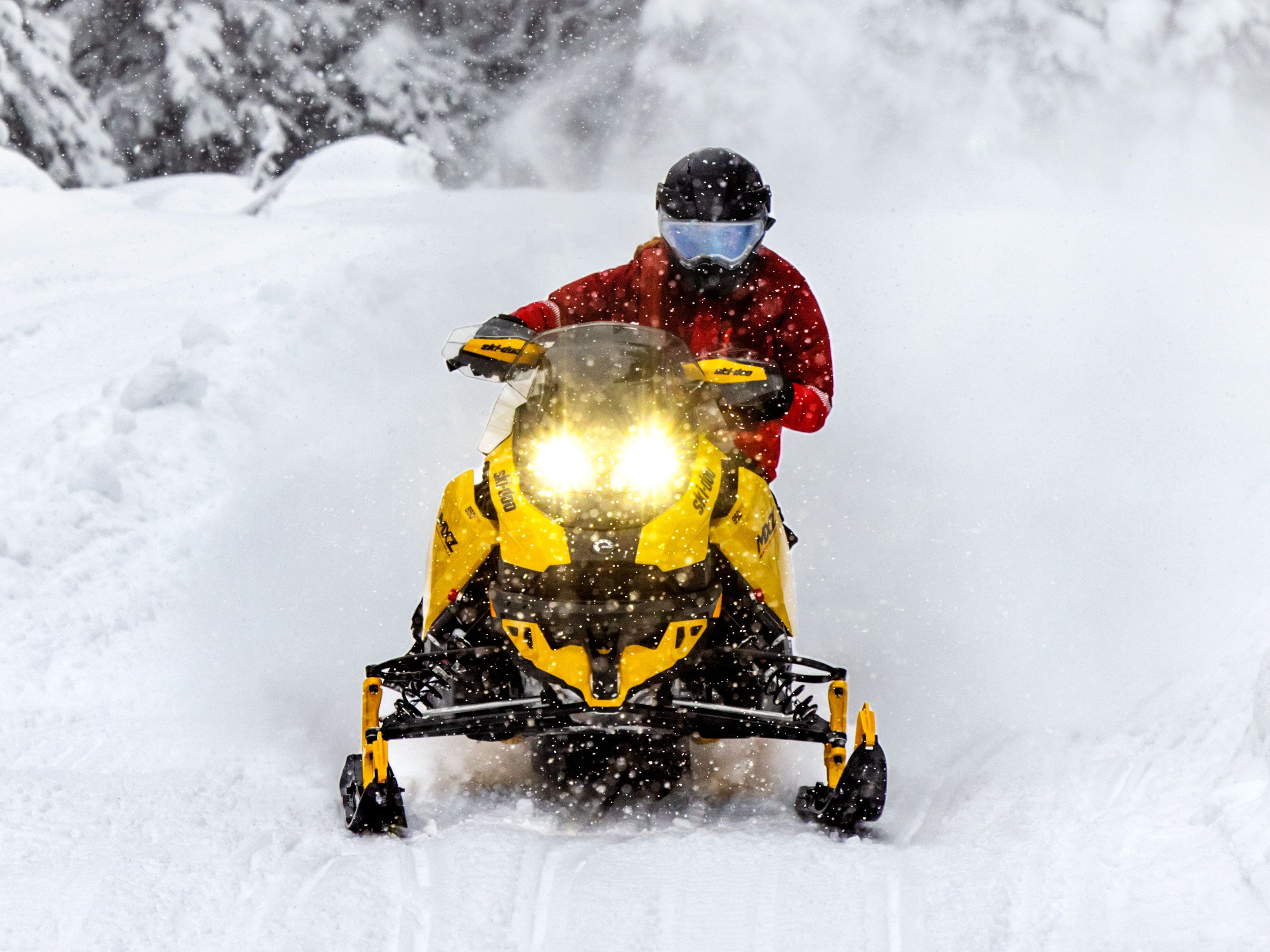 Woman on a MXZ Blizzard speeding on a trail