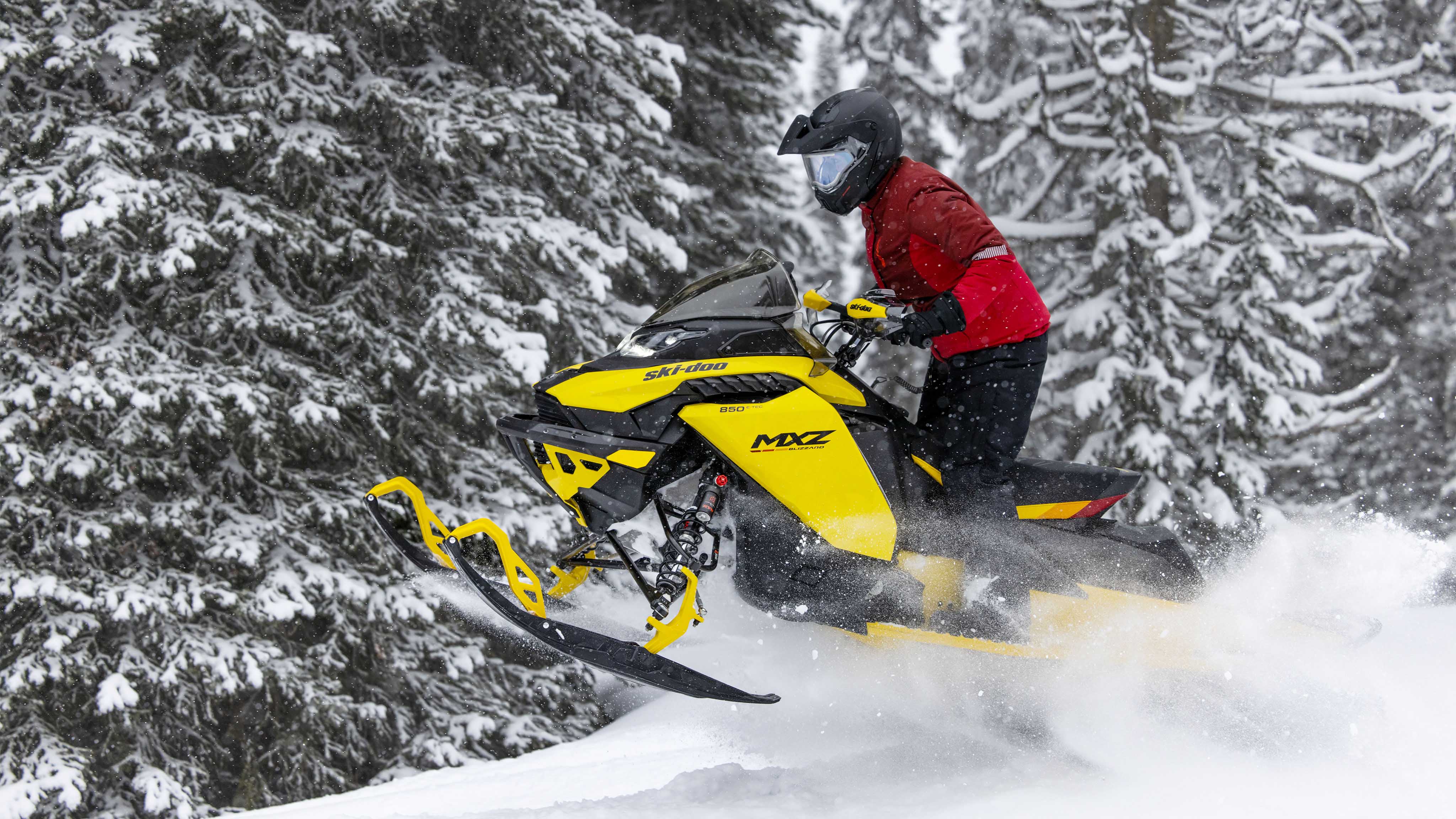 Woman jumping with his 2023 Ski-Doo MXZ