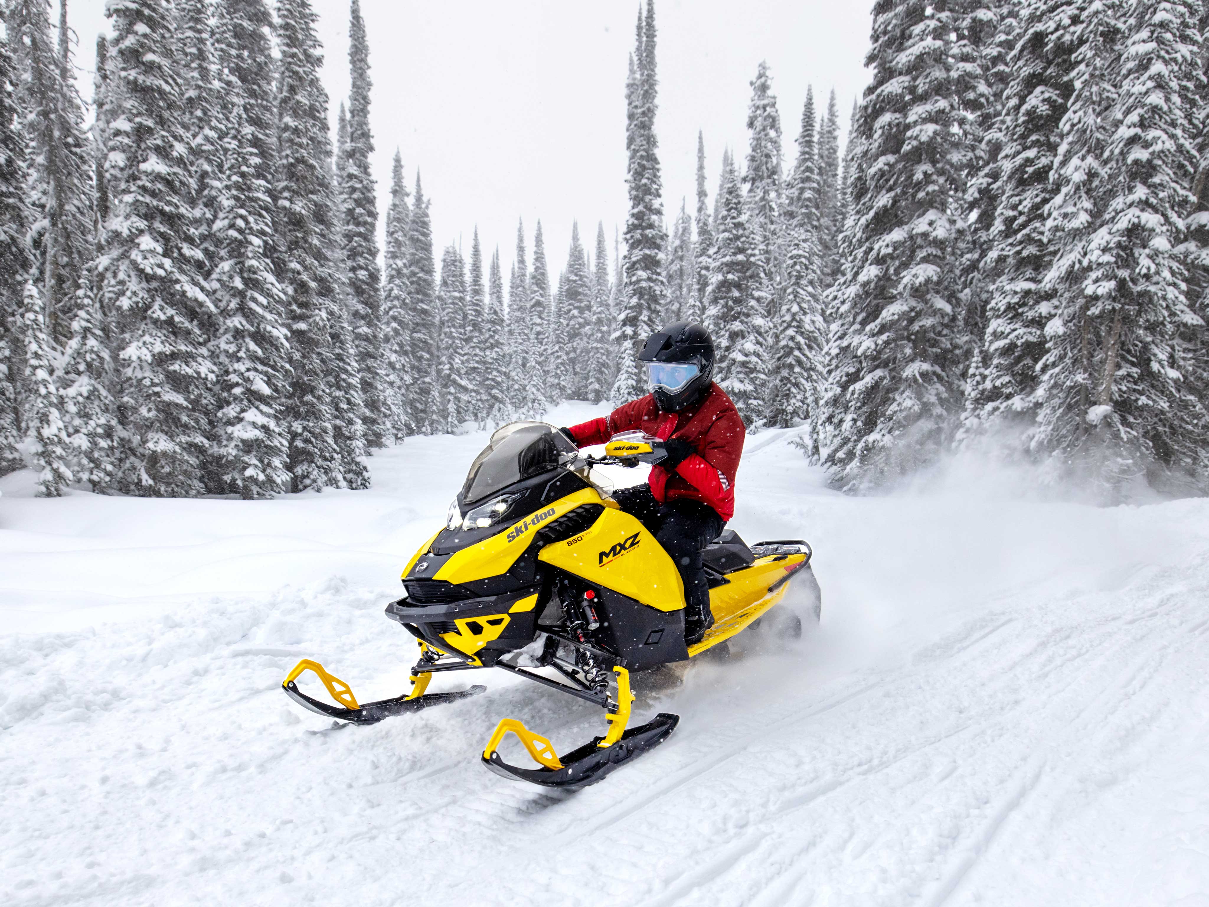 Woman riding a 2023 Ski-Doo MXZ on a trail