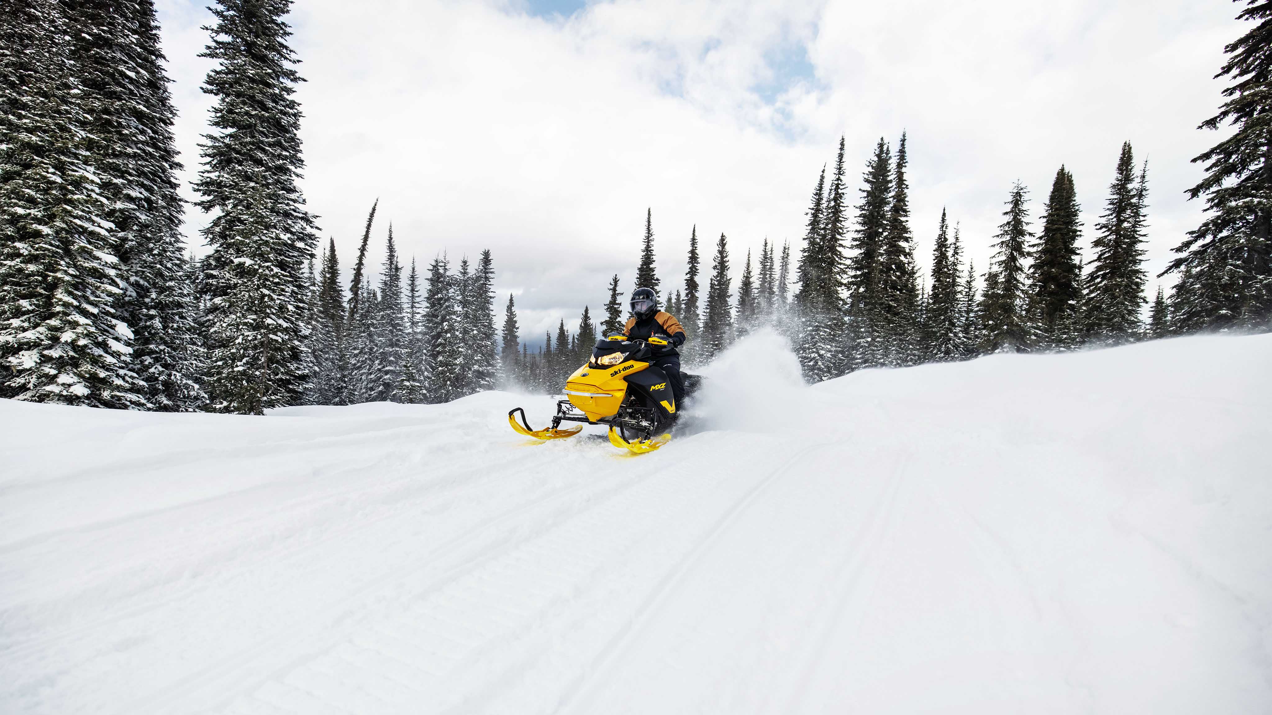 Man snowmobiling with the 2023 Ski-Doo MXZ Neo