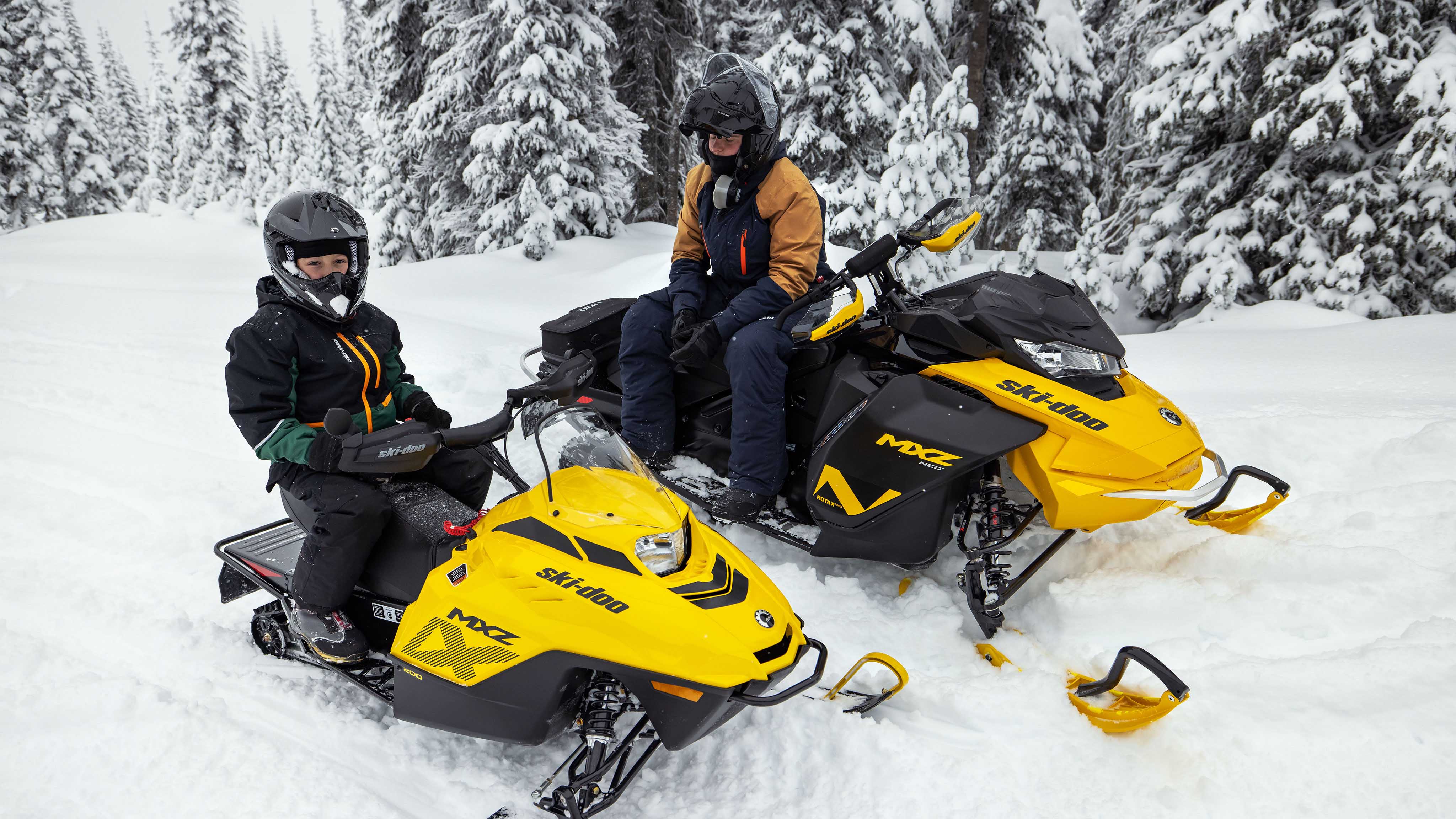 Man and his son during a snowmobile ride