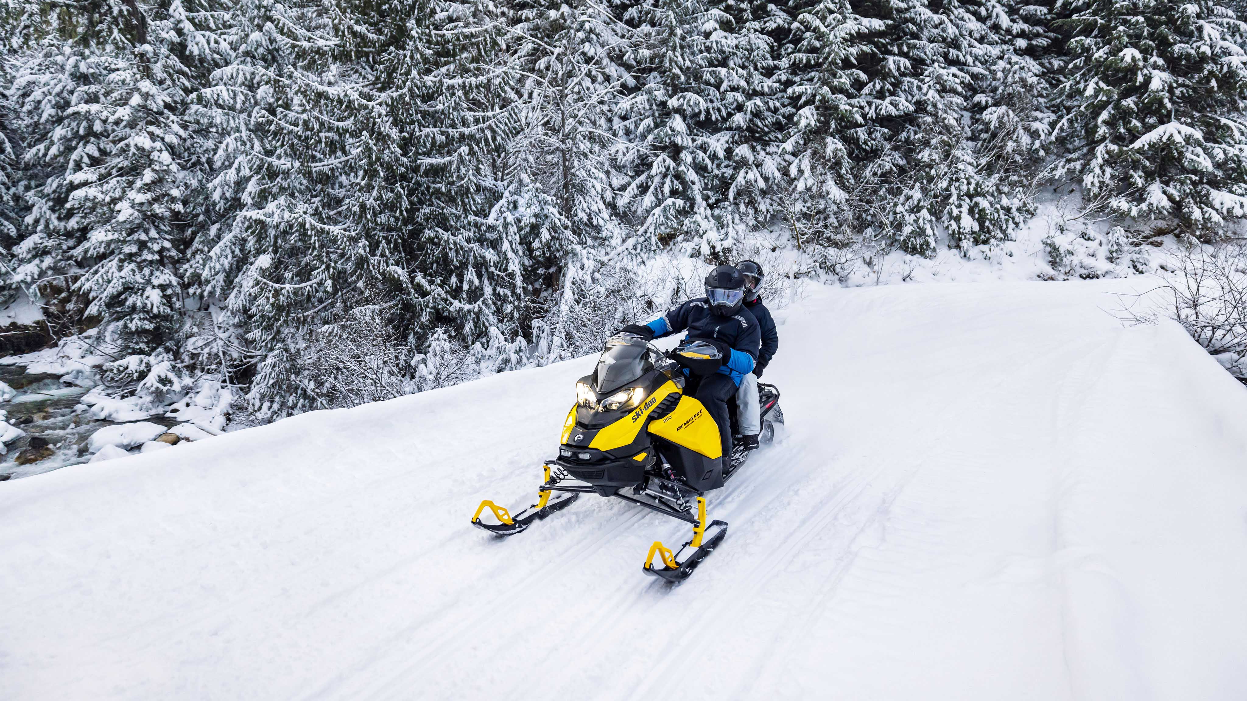 Couple enjoying snowmobile ride with a 2023 Ski-Doo Renegade