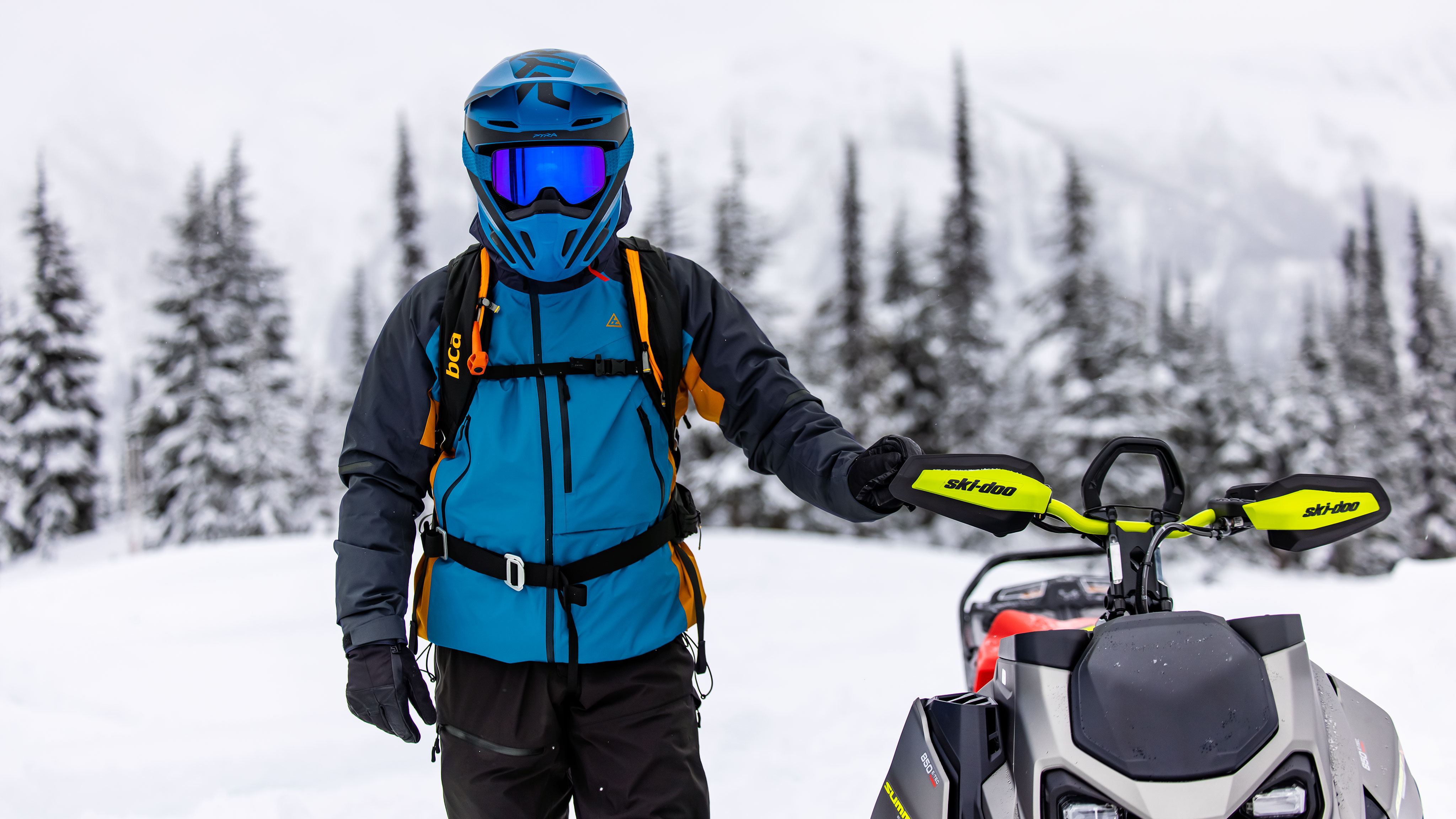 Man standing next to his Ski-Doo Summit