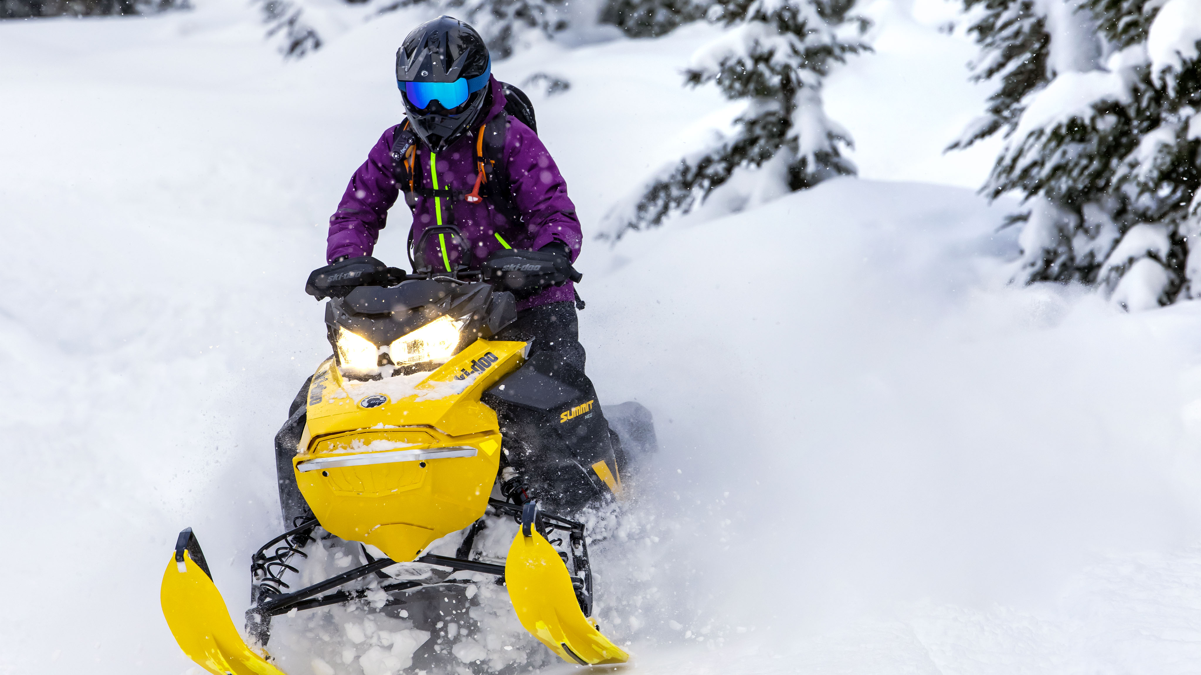 Woman speeding with the new snowmobile Ski-Doo Summit Neo