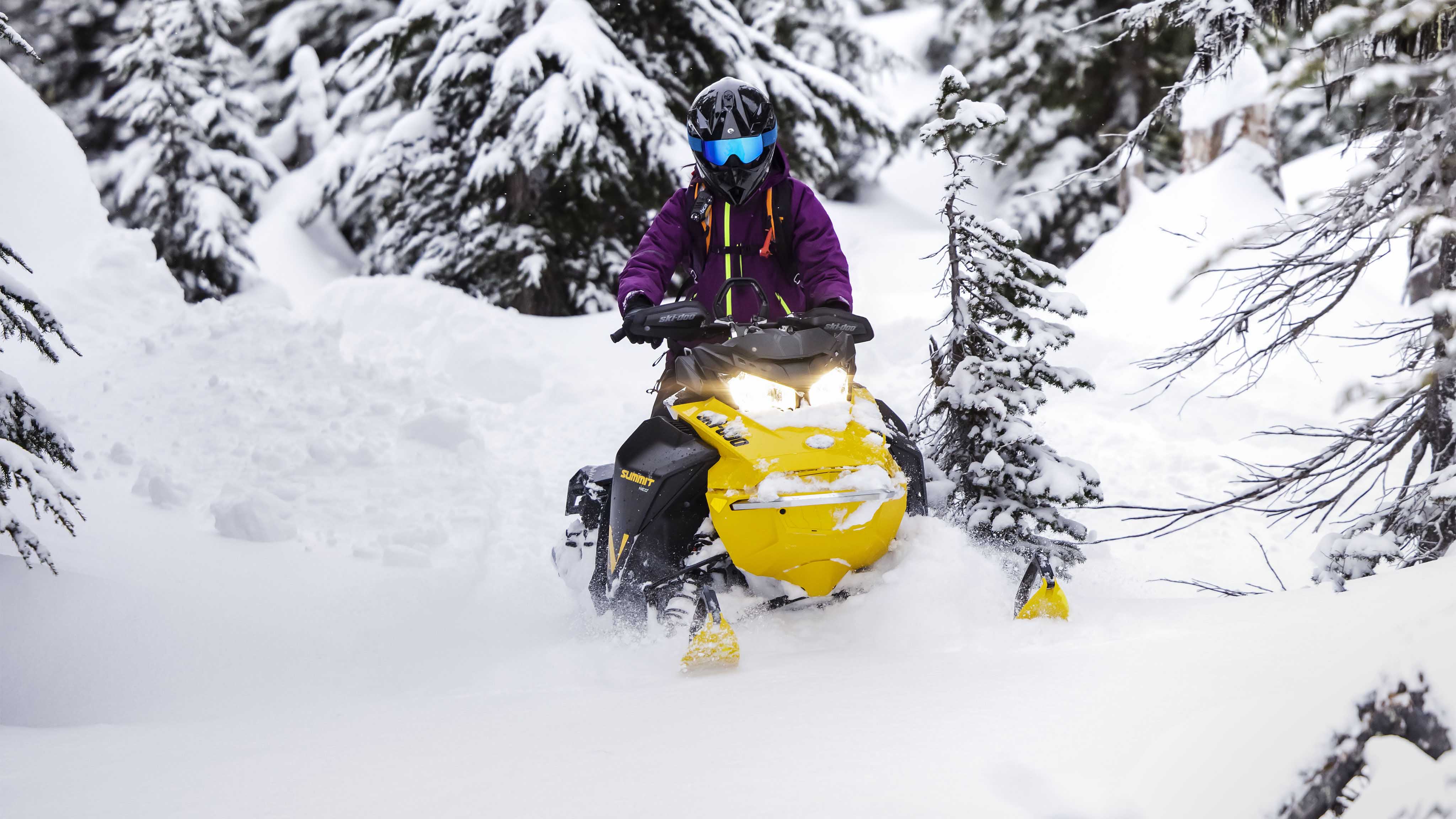 Woman enjoying deep snow with her Ski-Doo Summit