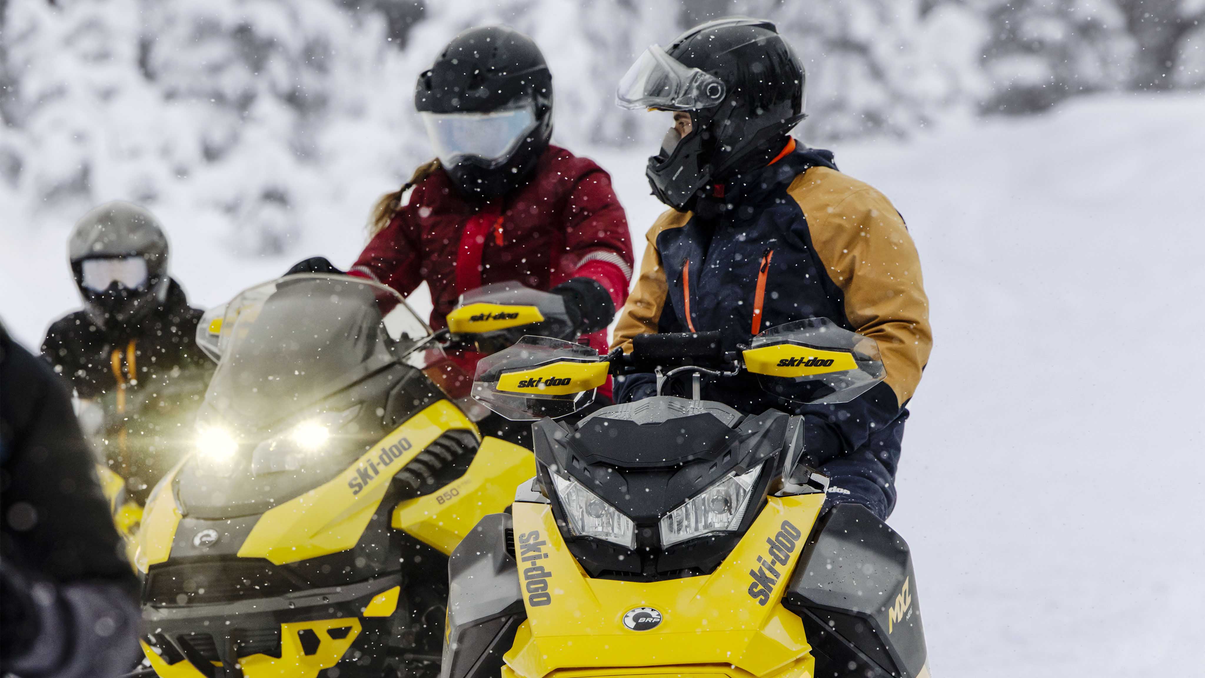 Family with the 2023 Ski-Doo MXZ snowmobiles