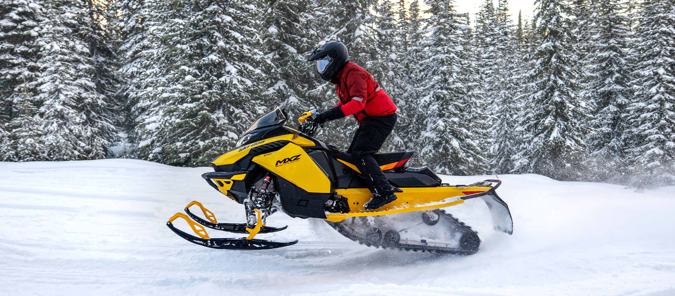 Woman driving a Ski-Doo MXZ Blizzard on a trail