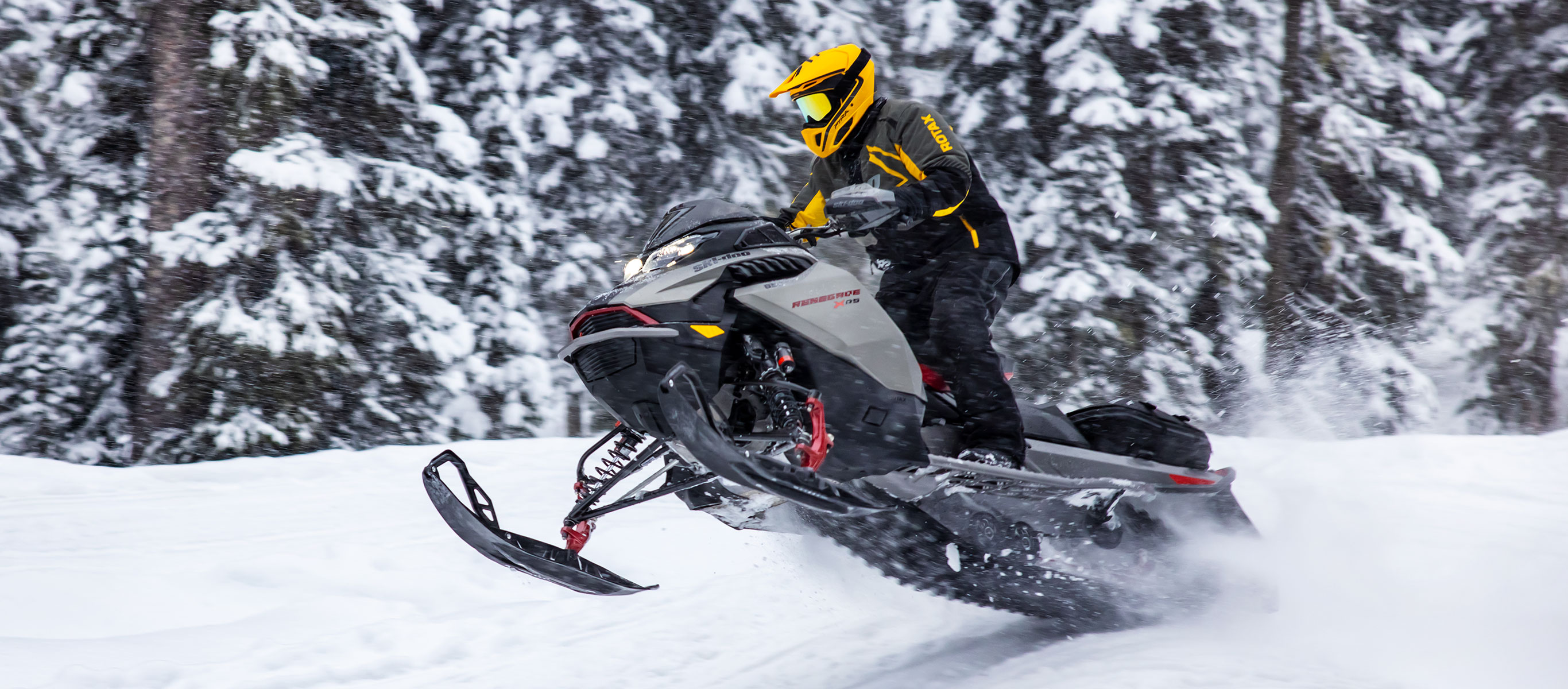 Man driving fast on a snowmobile trail with the new Ski-Doo Renegade